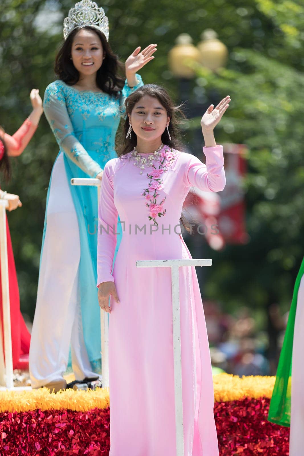 Washington, D.C., USA - July 4, 2018, The National Independence Day Parade, Vietnamese American women wearing traditional dresses, going down constitution avenue