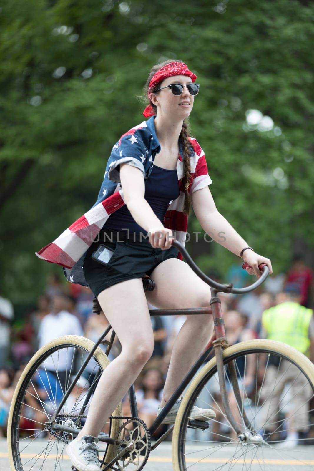 Washington, D.C., USA - July 4, 2018, The National Independence Day Parade, People riding antique bicycles down constitution avenue during the parade