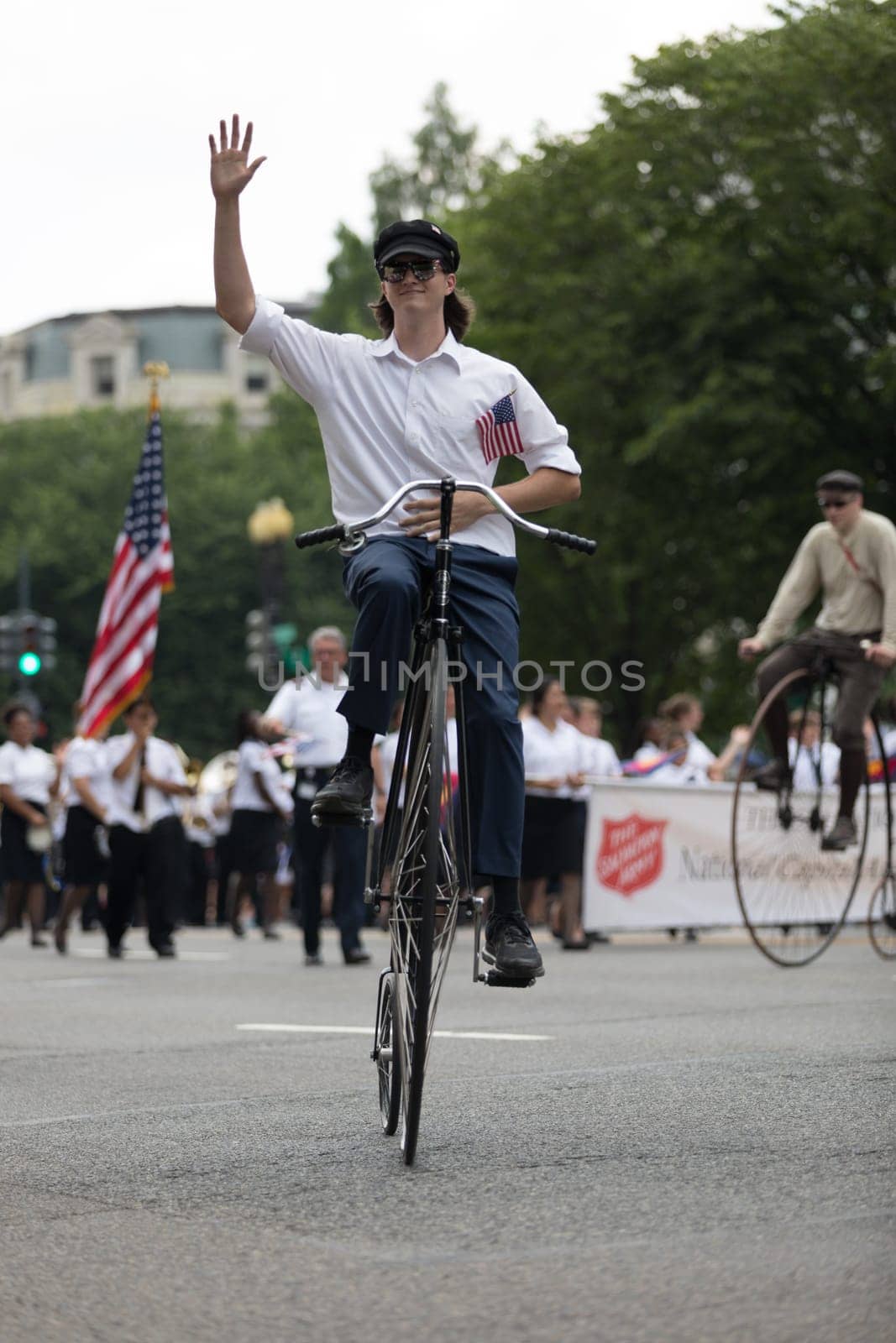 Washington, D.C., USA - July 4, 2018, The National Independence Day Parade, People riding antique bicycles down constitution avenue during the parade