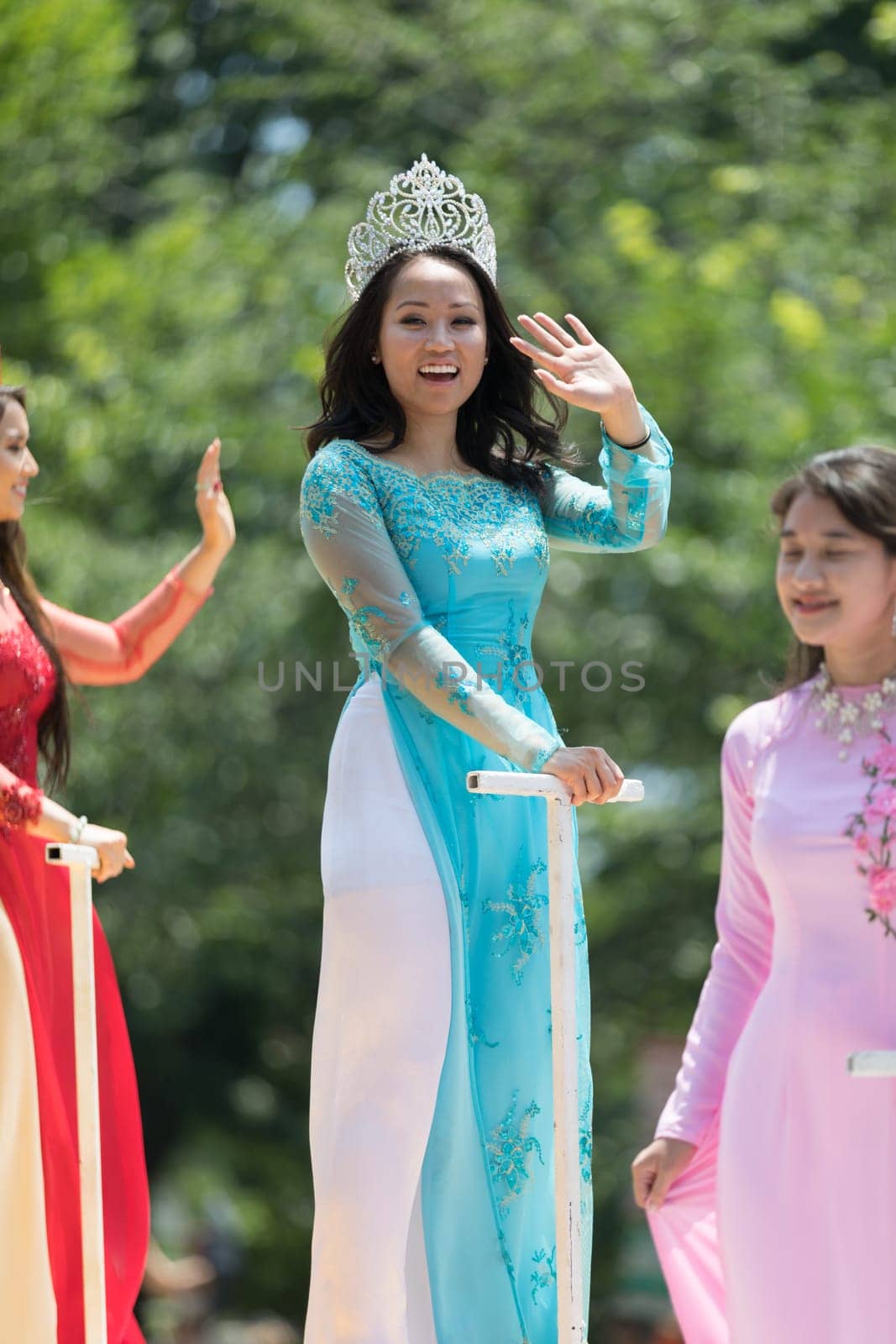 Washington, D.C., USA - July 4, 2018, The National Independence Day Parade, Vietnamese American women wearing traditional dresses, going down constitution avenue