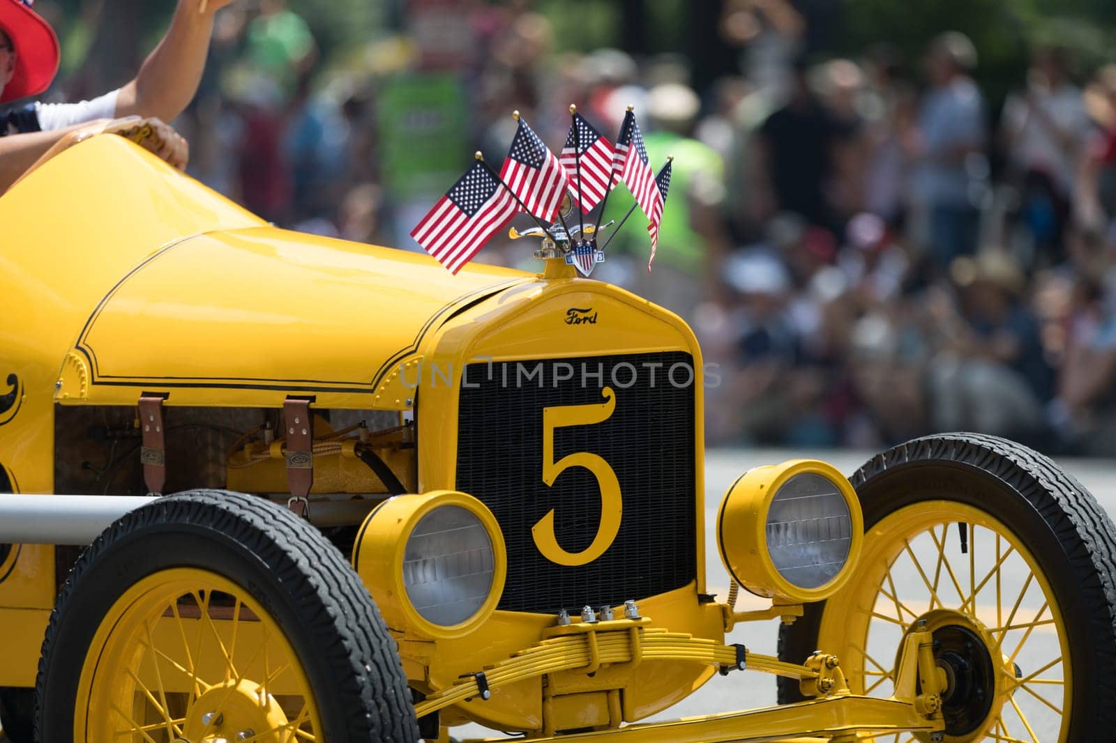 Washington, D.C., USA - July 4, 2018, The National Independence Day Parade, The Ford Model T Speedster race car, carrying american flags, going down constitution avenue