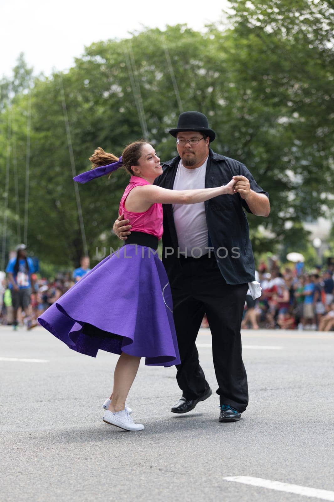 Washington, D.C., USA - July 4, 2018, The National Independence Day Parade, The Gottaswing Dancers, with outfits from the 60s, going down constitution avenue