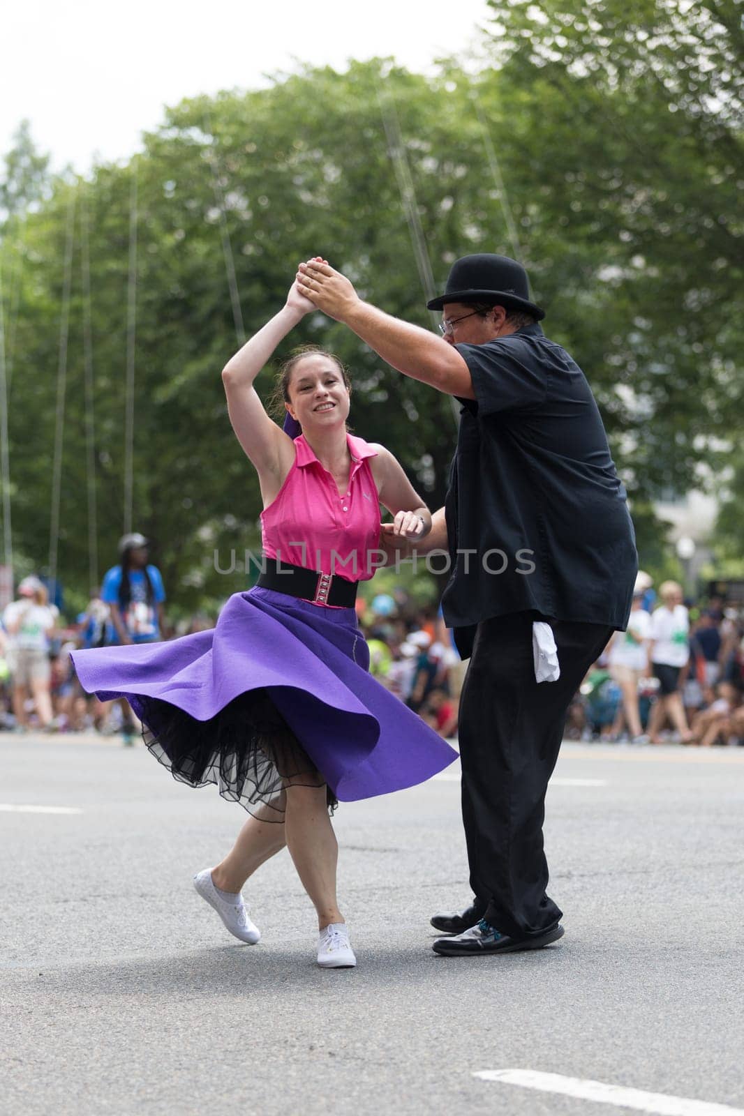 Washington, D.C., USA - July 4, 2018, The National Independence Day Parade, The Gottaswing Dancers, with outfits from the 60s, going down constitution avenue