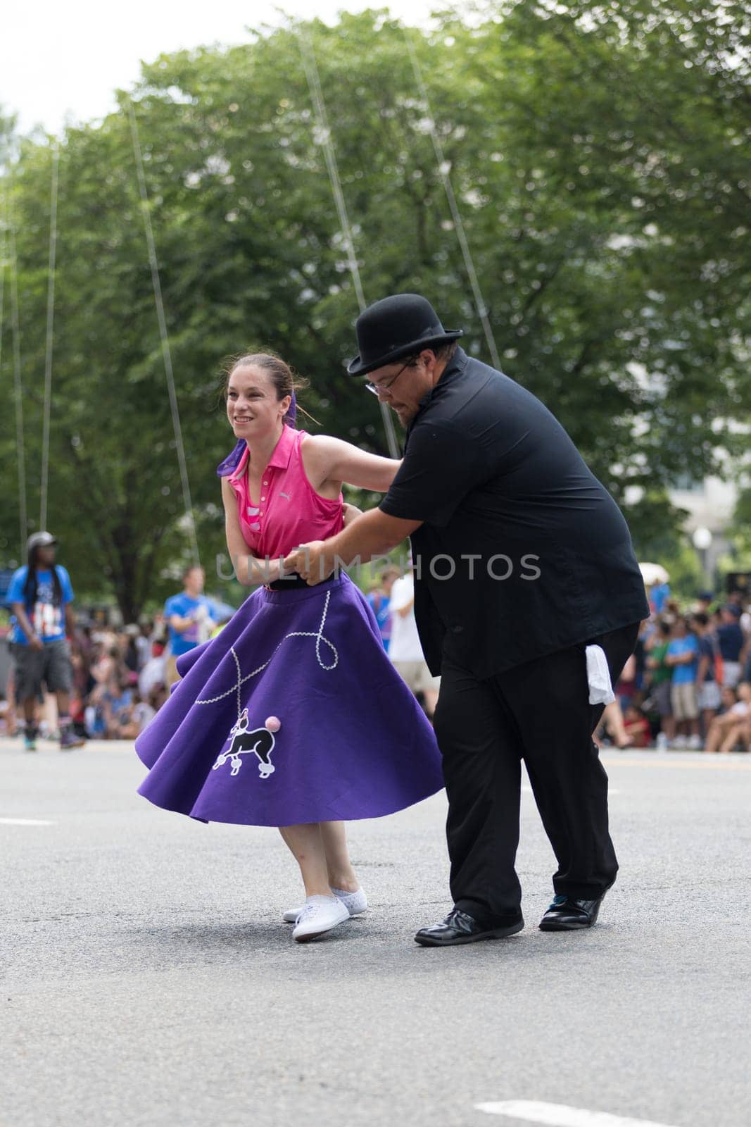 Washington, D.C., USA - July 4, 2018, The National Independence Day Parade, The Gottaswing Dancers, with outfits from the 60s, going down constitution avenue