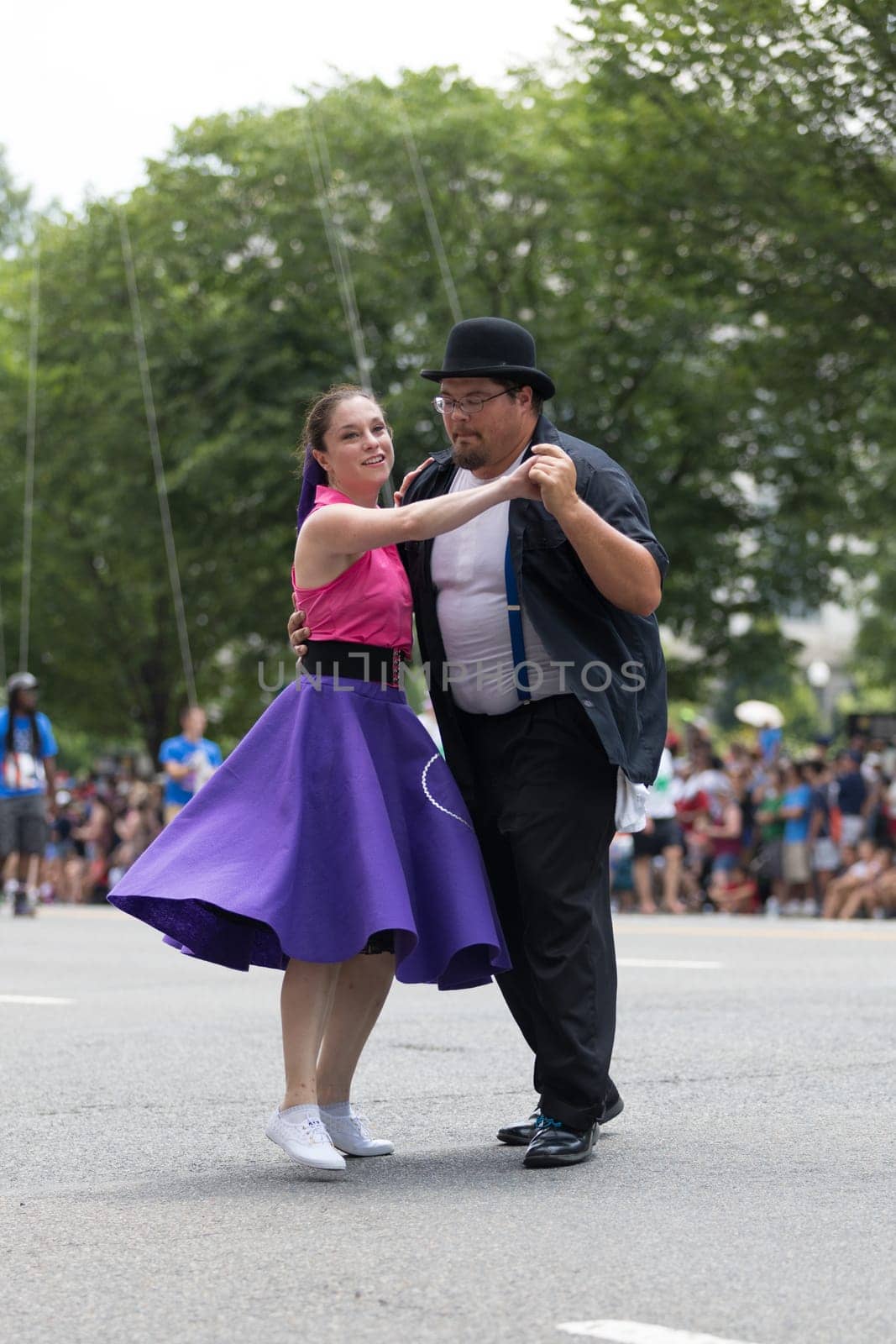 Washington, D.C., USA - July 4, 2018, The National Independence Day Parade, The Gottaswing Dancers, with outfits from the 60s, going down constitution avenue