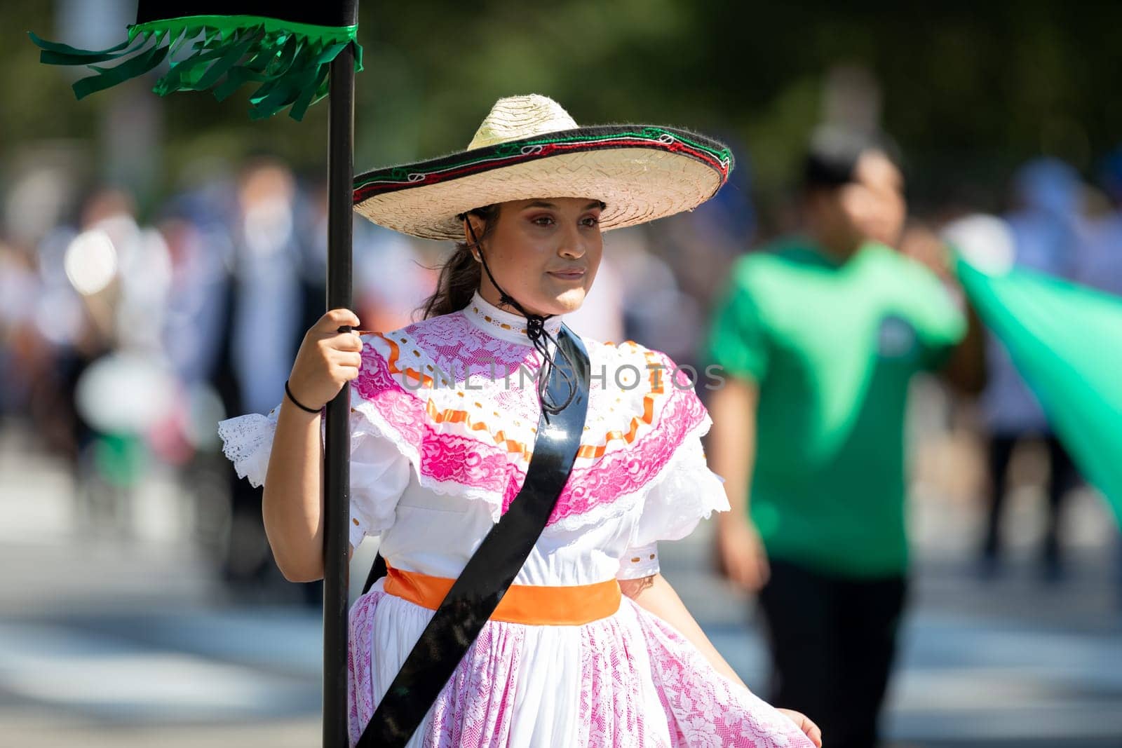Washington, D.C., USA - September 29, 2018: The Fiesta DC Parade, Woman wearing traditional clothing from Mexico carrying a banner