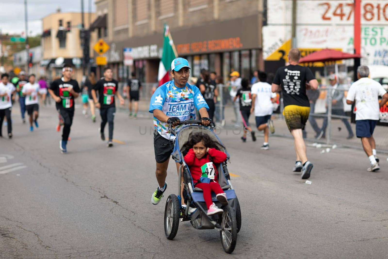 Chicago, Illinois , USA - September 9, 2018, El Grito 5K at la Villita, family run walk, men and women running in the annual 5 kilometers race, prior to the 26th street Mexican Independence Day Parade