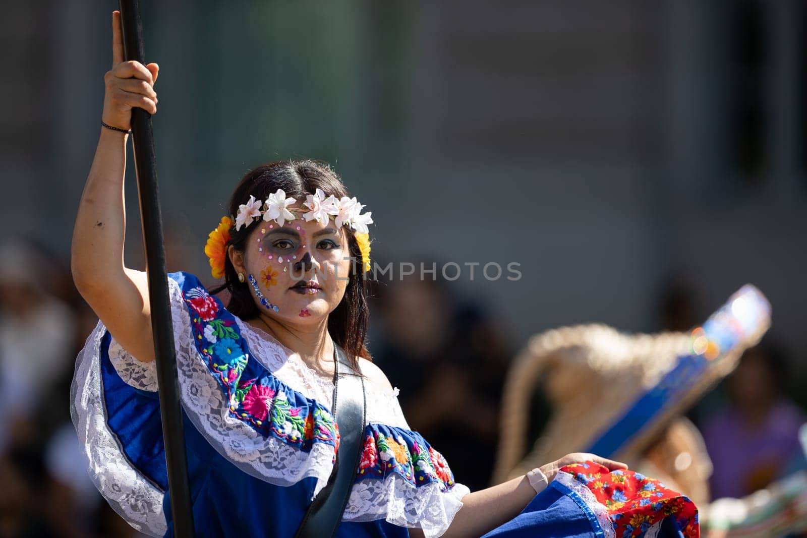 Washington, D.C., USA - September 29, 2018: The Fiesta DC Parade, Mexican woman wearing traditional clothing with face paint as sugar skull