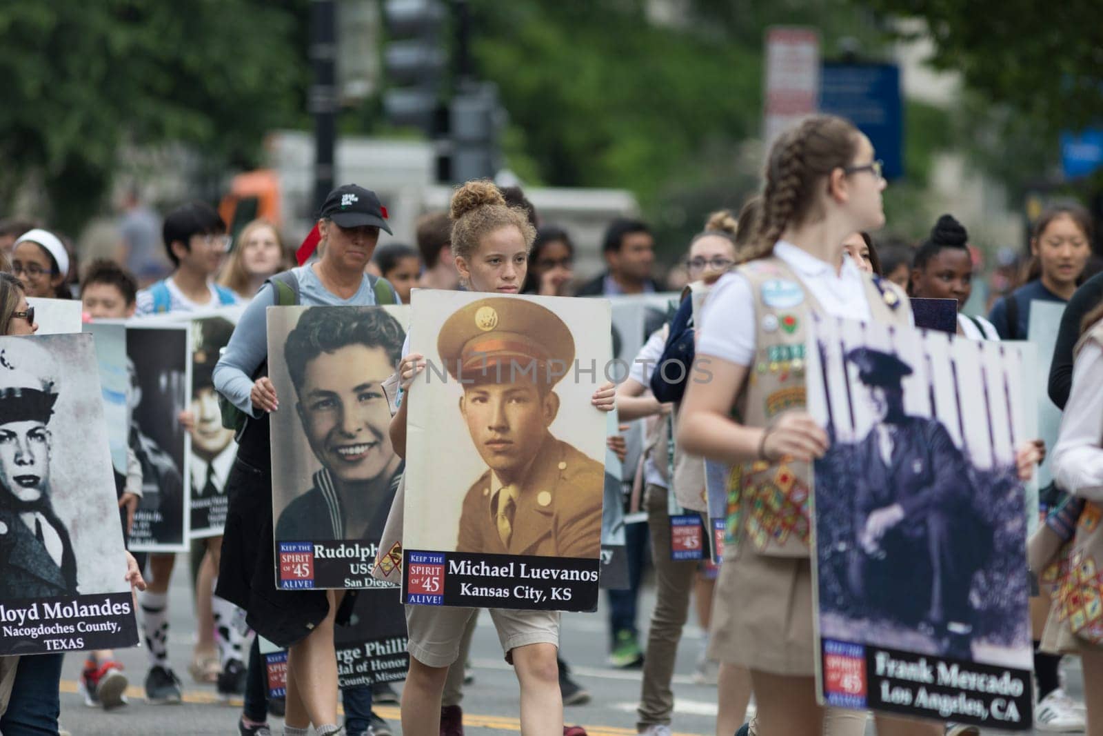 Washington, D.C., USA - May 28, 2018: The National Memorial Day Parade, People carry portraits of world war two military personel down constitution avenue