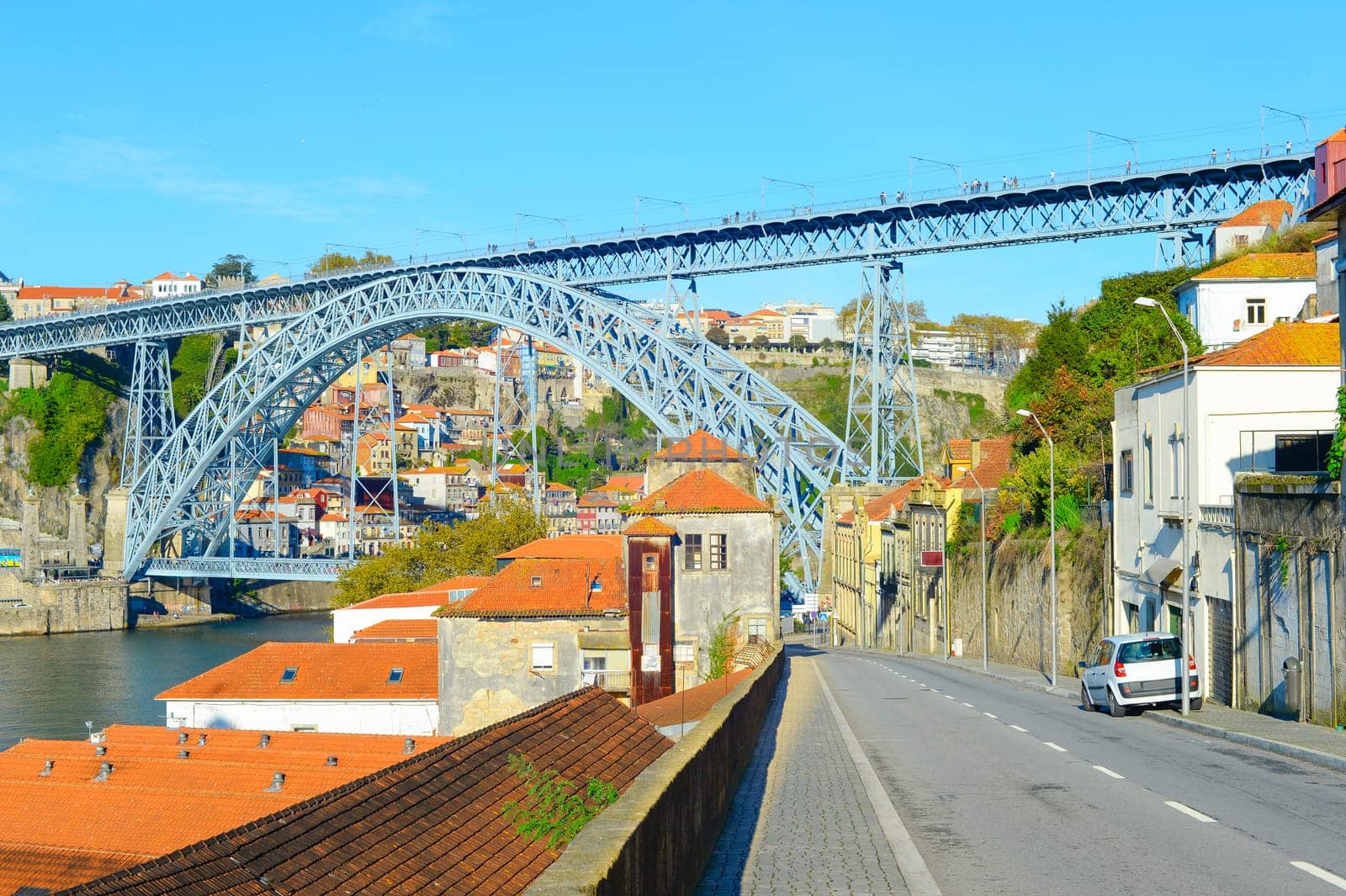 Porto oldtown with famous Dom Luis I Bridge bottom view in bright sunlight, POrtugal