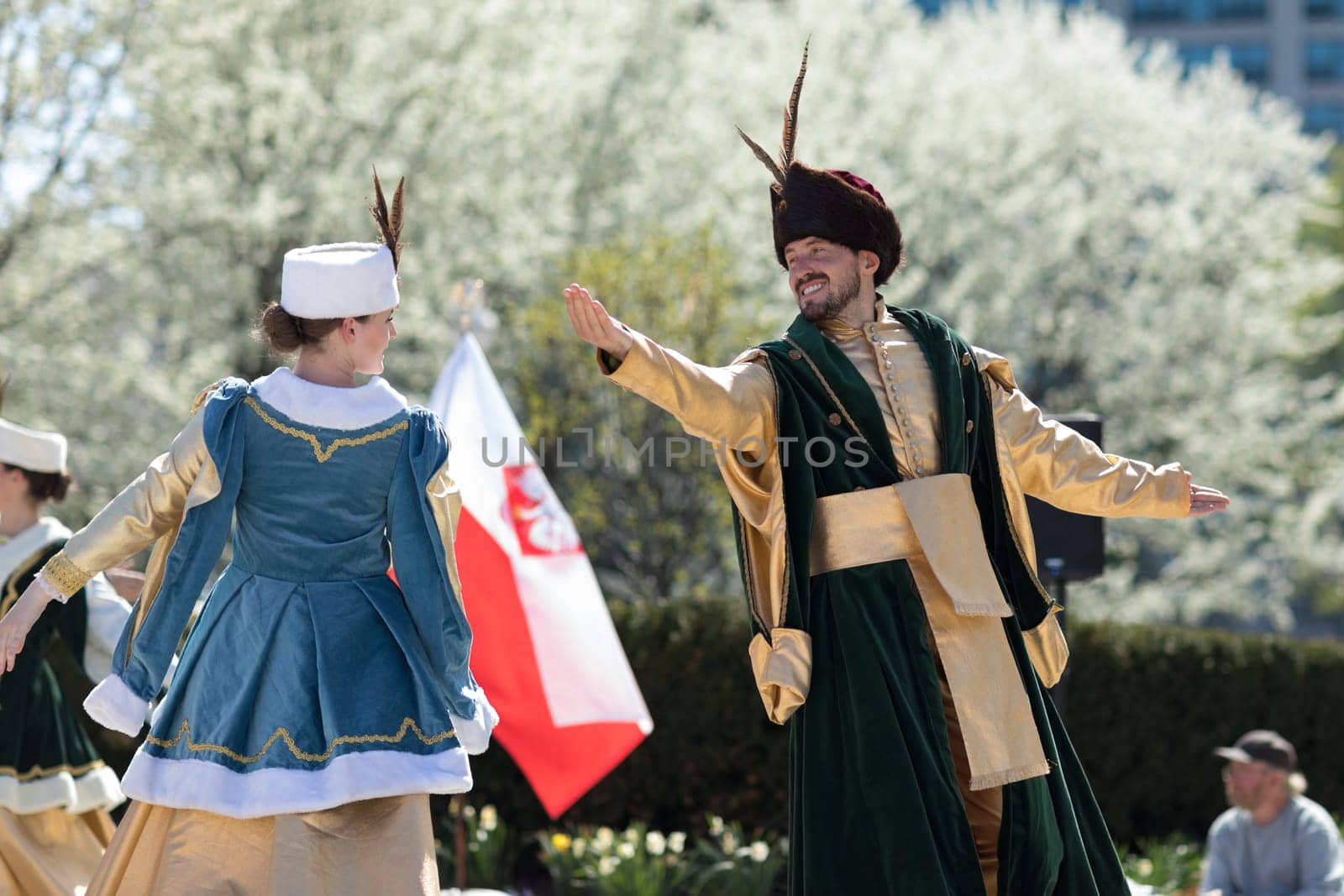 Chicago, Illinois, USA - May 05, 2018 Members of Polonia, polish folk song and dance ensemble, wearing traditional clothing, perform polish traditional dancing at the Grant Park, after the Polish Constitution Day Parade.