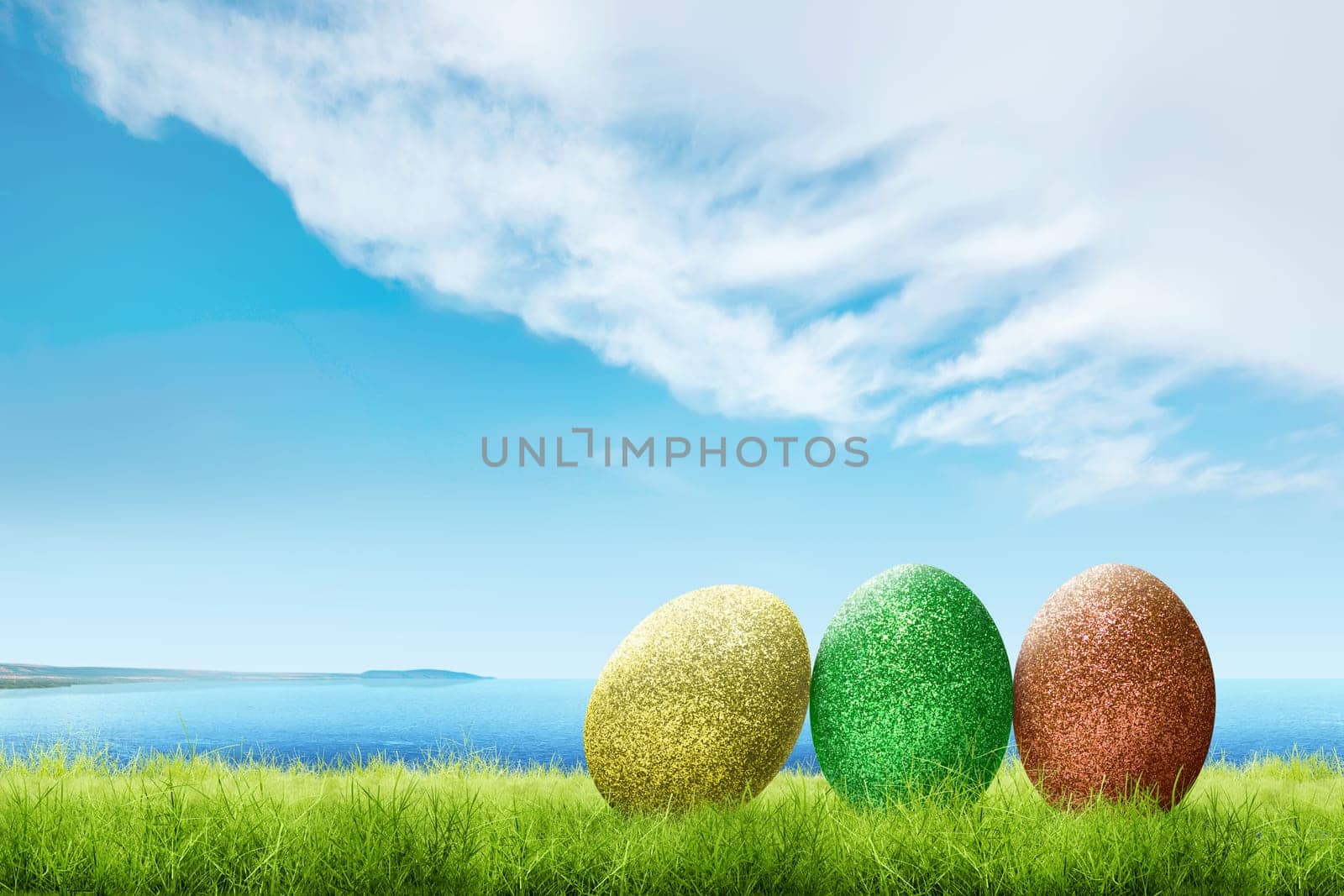 Colorful easter eggs on the green grass with blue ocean view and cloudscapes over blue sky background. Happy Easter