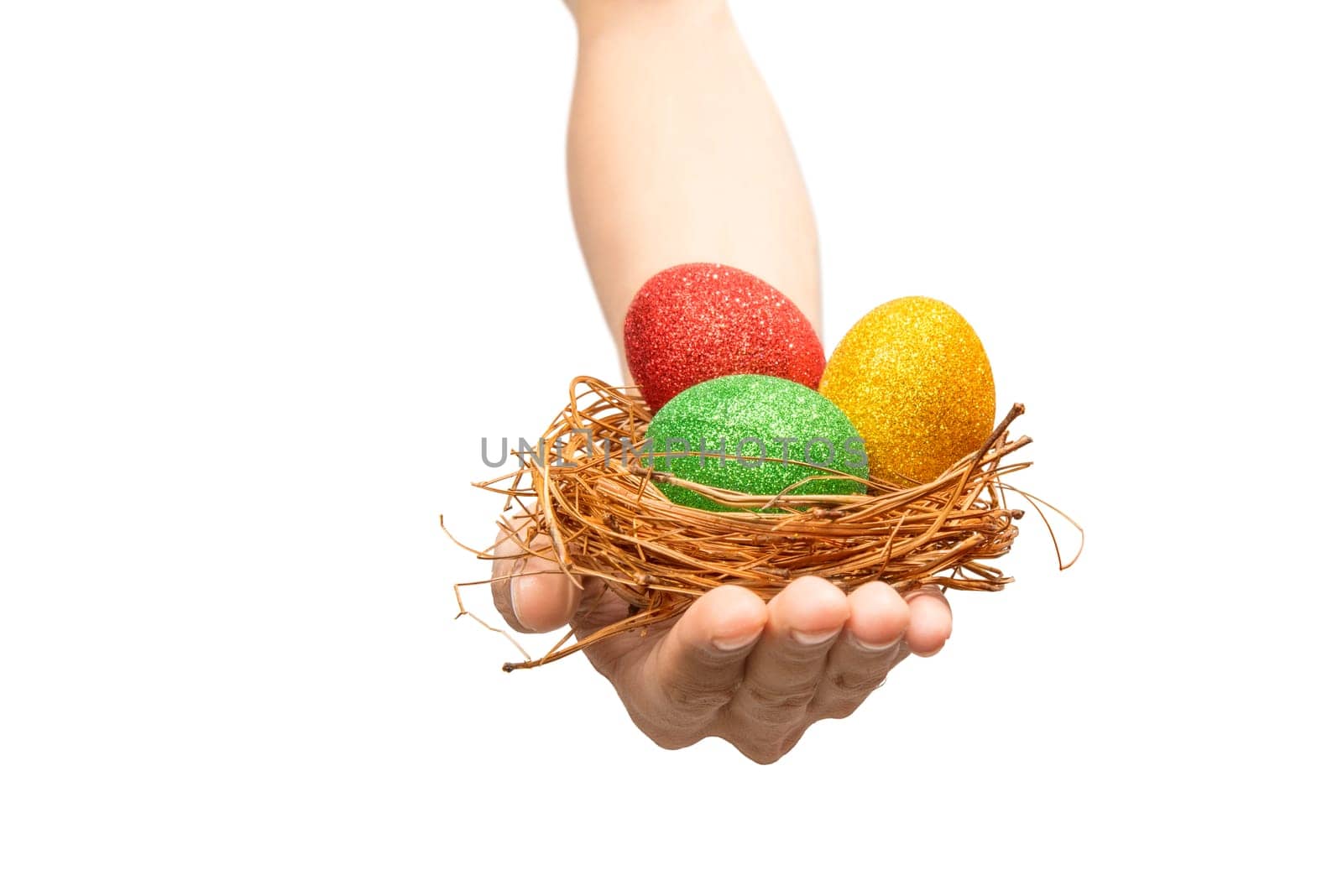 Human hand holding the nest with colorful easter eggs isolated over white background. Happy Easter