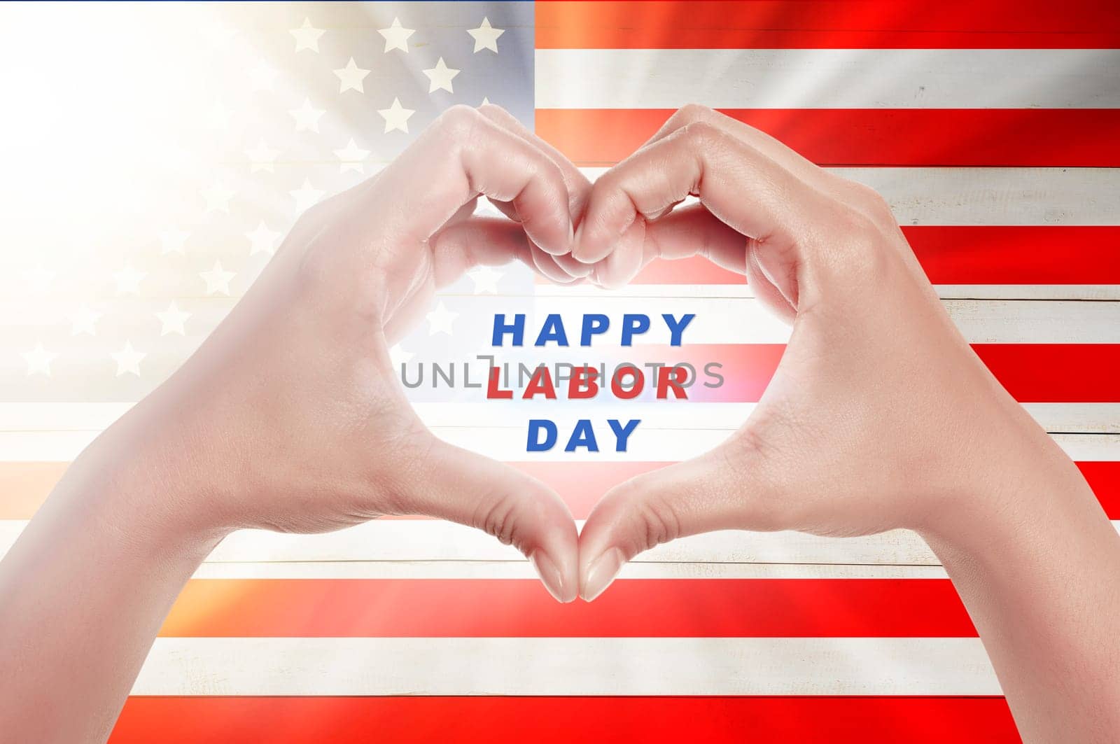 Human hands in heart shape with Happy labor day text over american flag background. Labor day concept