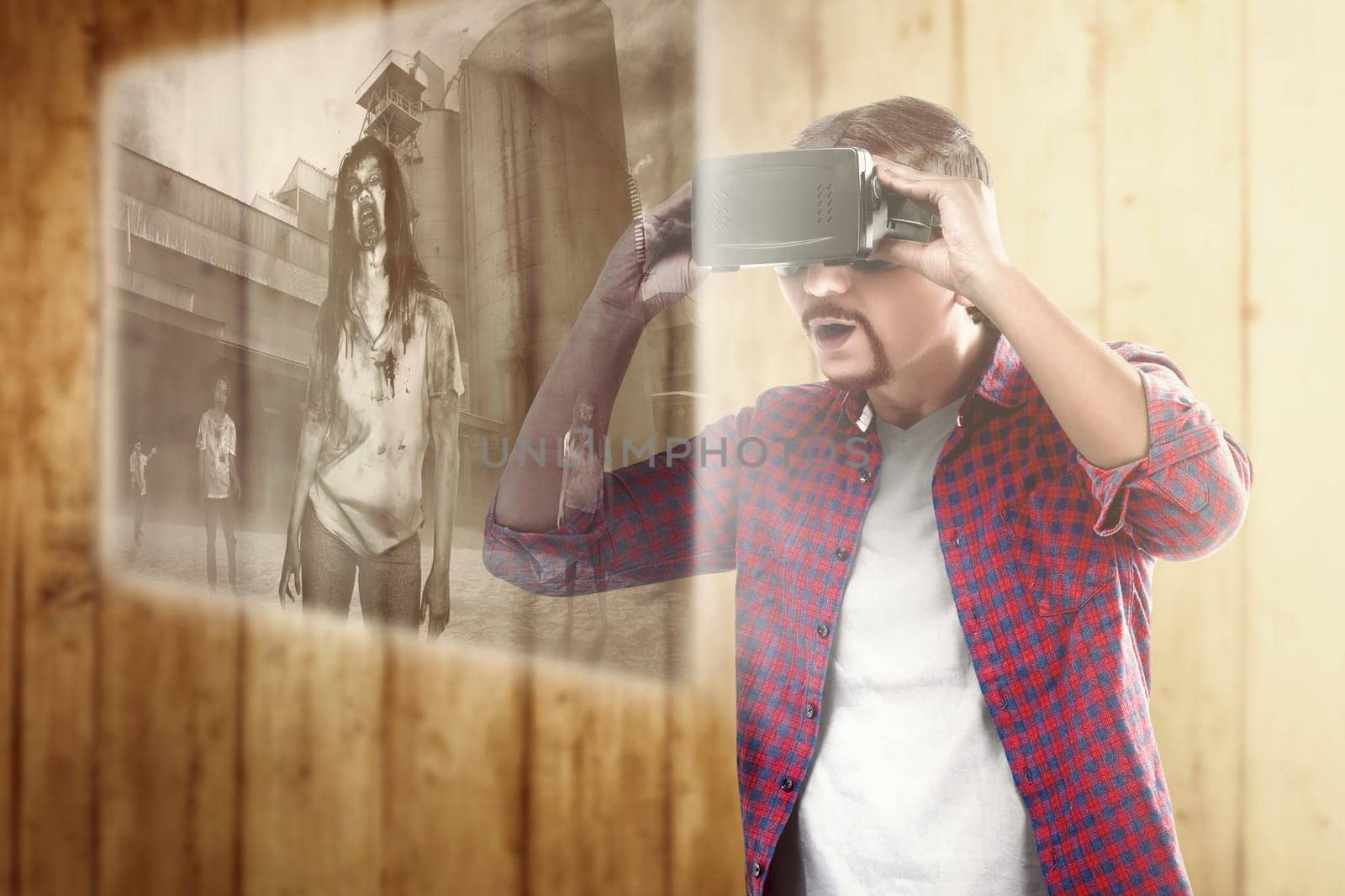 Asian man looking at digital interface with virtual reality device display the horror movies of zombies. Augmented reality technology