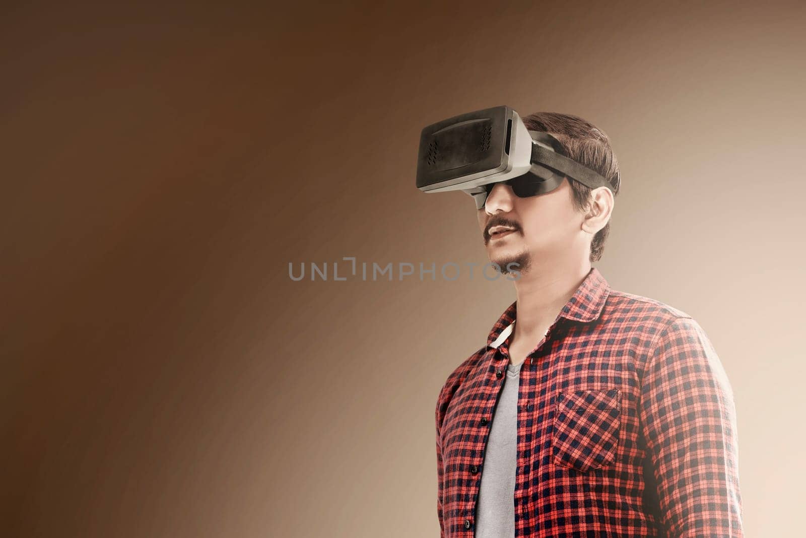 Asian man using virtual reality device. Augmented reality technology