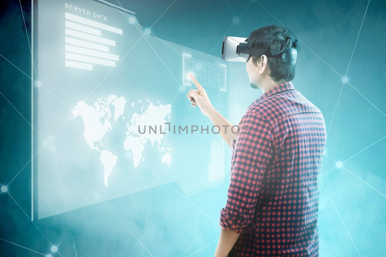 Rear view of asian man touching binary code on digital interface with virtual reality device display the world map, graphic bar and binary code. Augmented reality technology