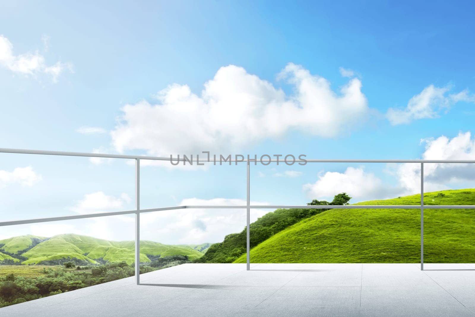 Terrace of building with iron fence and green landscapes view with blue sky background