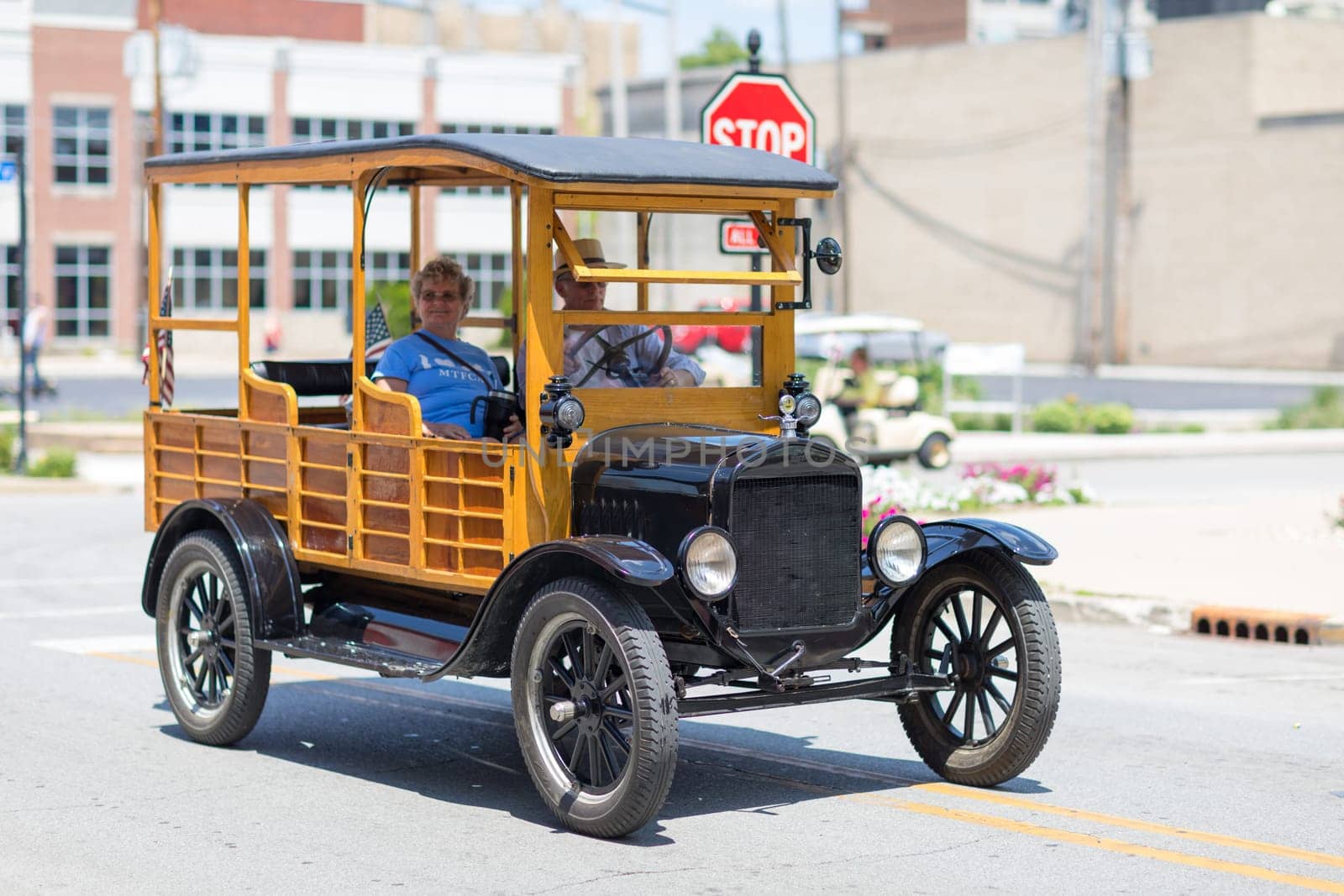 Kokomo, Indiana, USA - June 30, 2018: Haynes Apperson Parade, Old Ford Classic Truck carrying the American flag and driving down the street