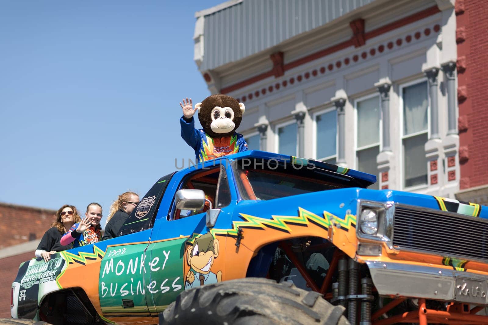 Orleans, Indiana, USA - April 28, 2018: The Orleans DogWood Festival and Parade, A Monster truck with a man dress up as a monkey and a sign that says Monkey Bussines going down the street