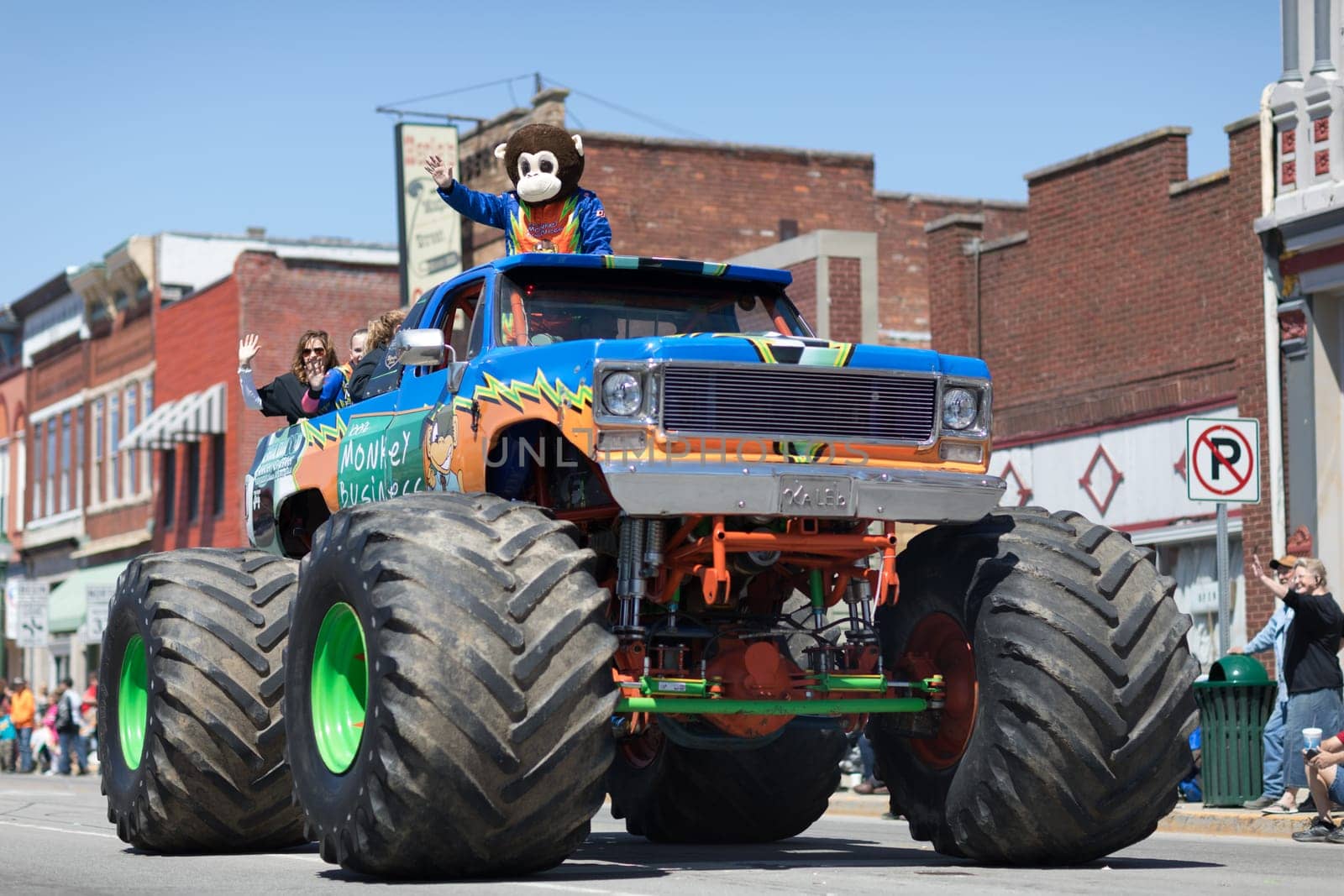 Orleans, Indiana, USA - April 28, 2018: The Orleans DogWood Festival and Parade, A Monster truck with a man dress up as a monkey and a sign that says Monkey Bussines going down the street