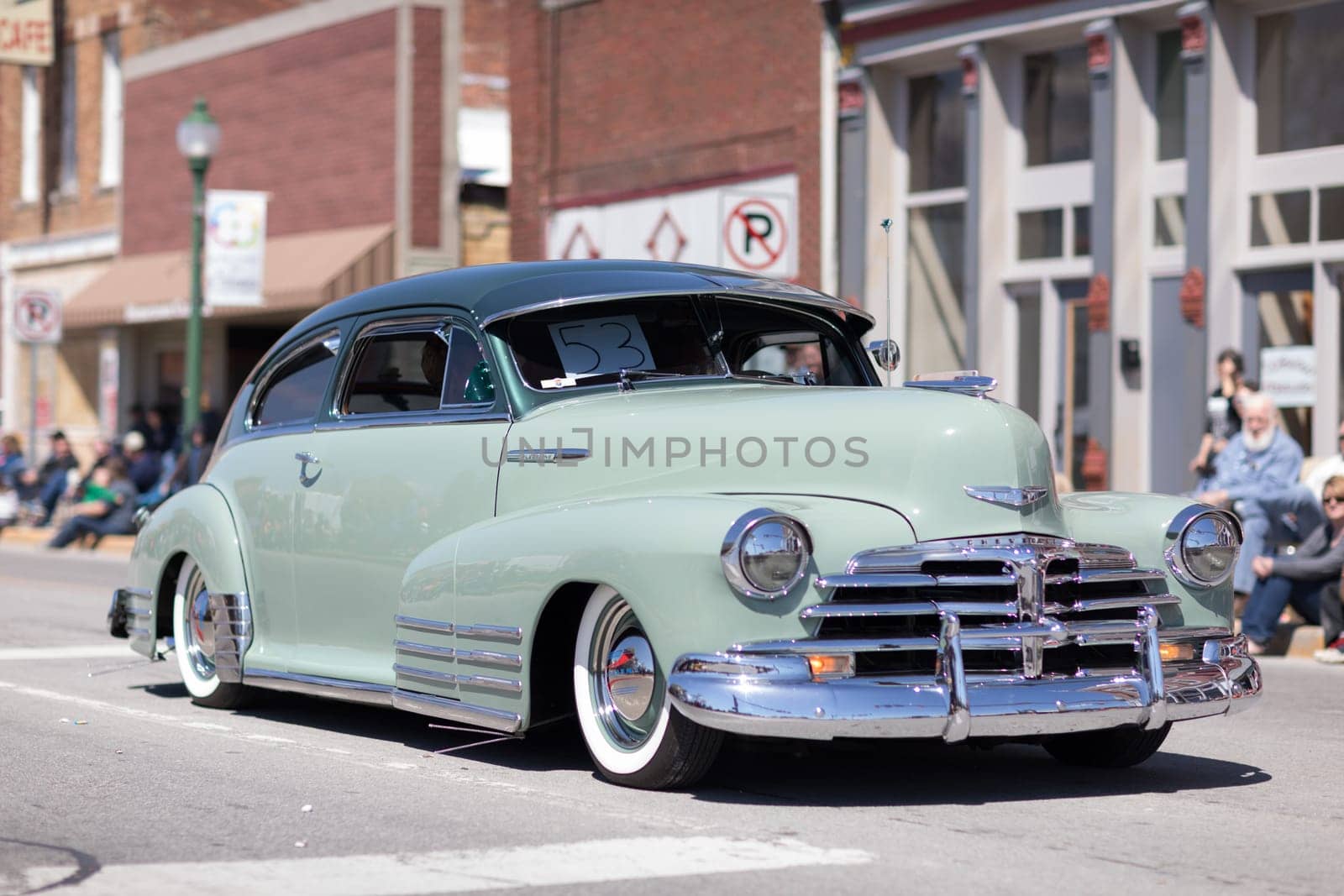 Orleans, Indiana, USA - April 28, 2018: The Orleans DogWood Festival and Parade, A classic car going down the street during the parade, a Chevrolet Fleetline color green