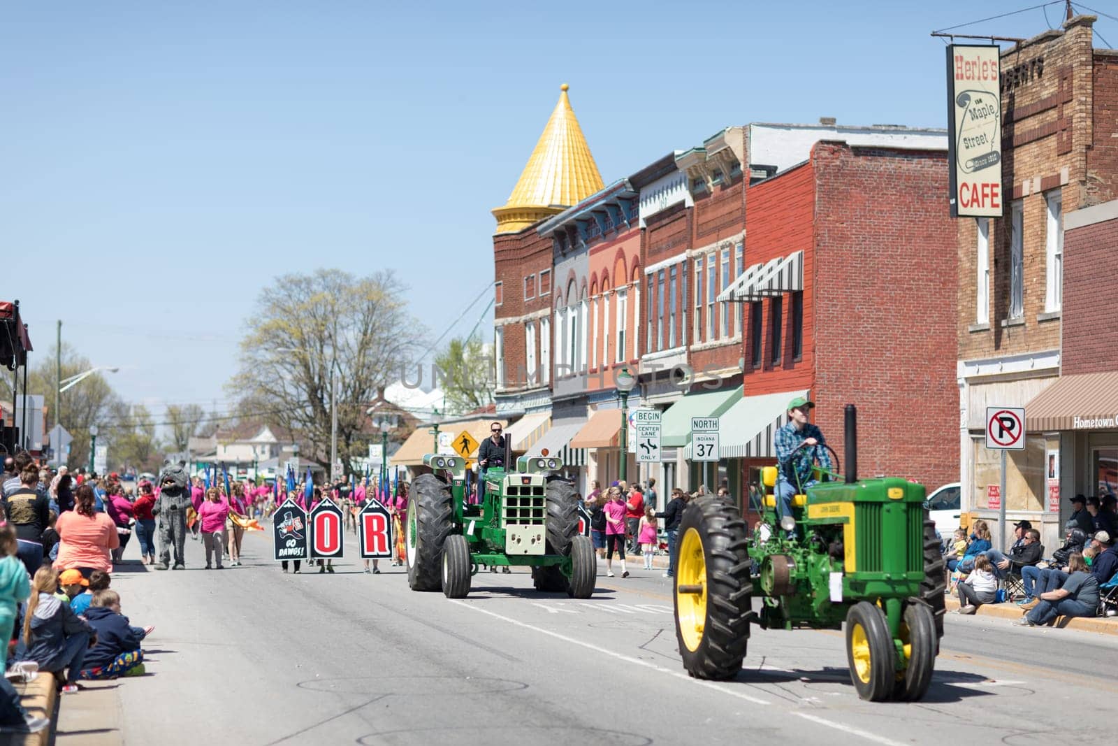 Orleans, Indiana, USA - April 28, 2018: The Orleans DogWood Festival and Parade, A John Deere and an Oliver classic tractors going down the street downtown Orleans