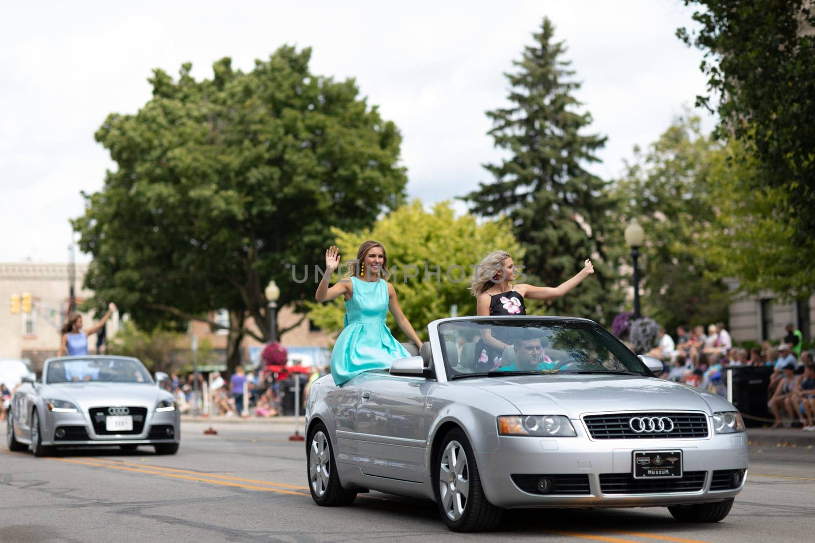 Auburn, Indiana, USA - September 9, 2018 The Auburn Cord Duesenberg Festival, Beauty contestants on a car going down the street waving at espectators