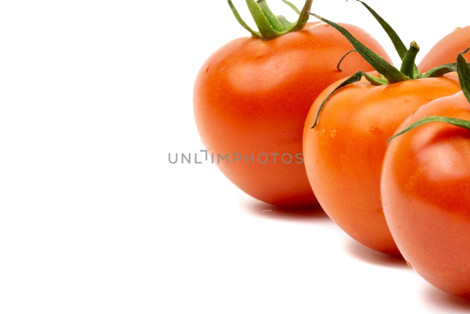 Tomato closeup on white background. Selective focus and crop fragment