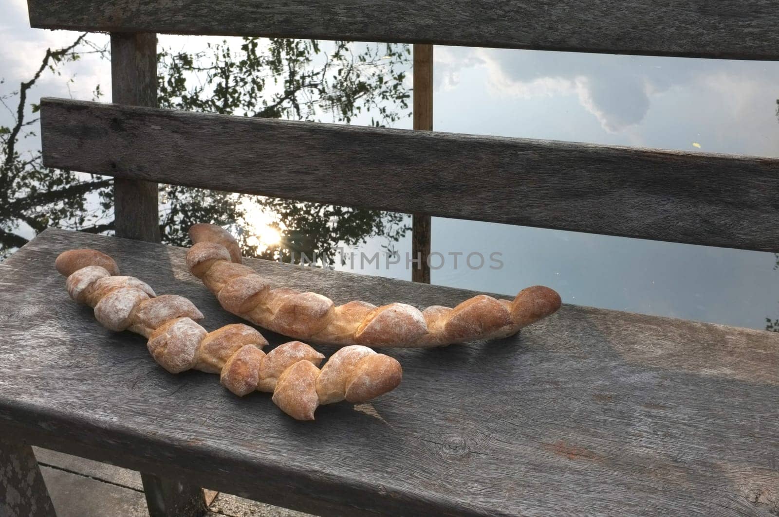 Two baguettes on the wooden chair  background . Concept Nature food , Organic food
