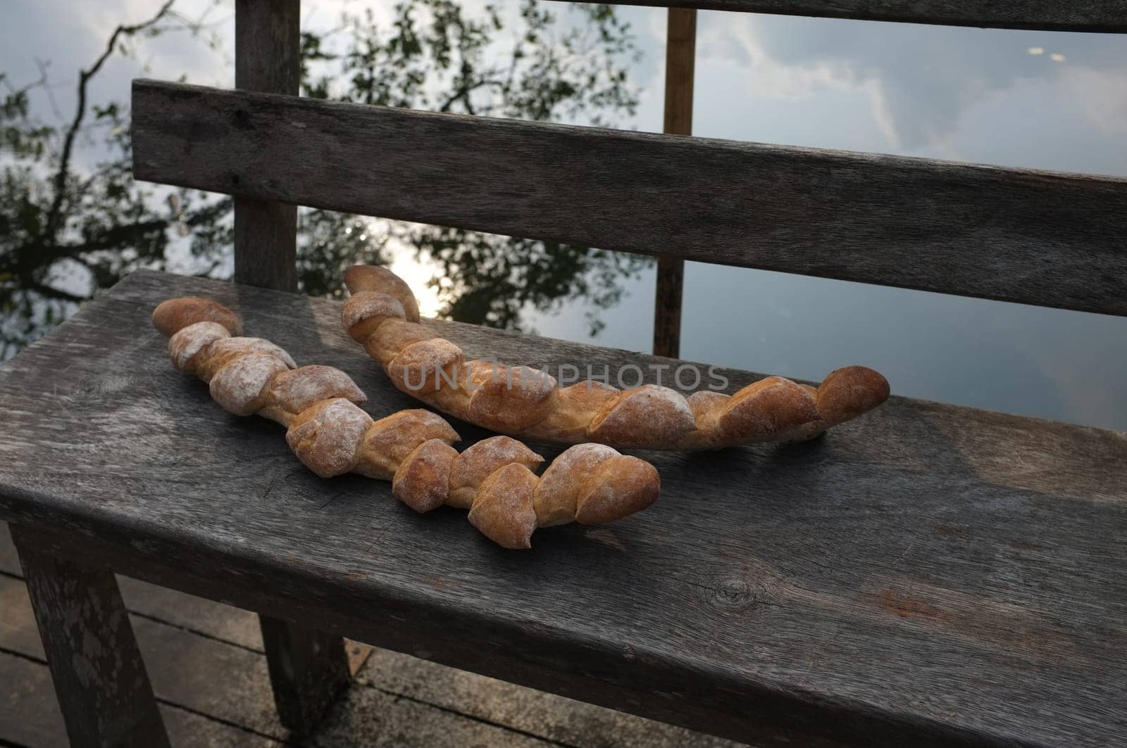Two baguettes on the wooden chair  background . Concept Nature food , Organic food