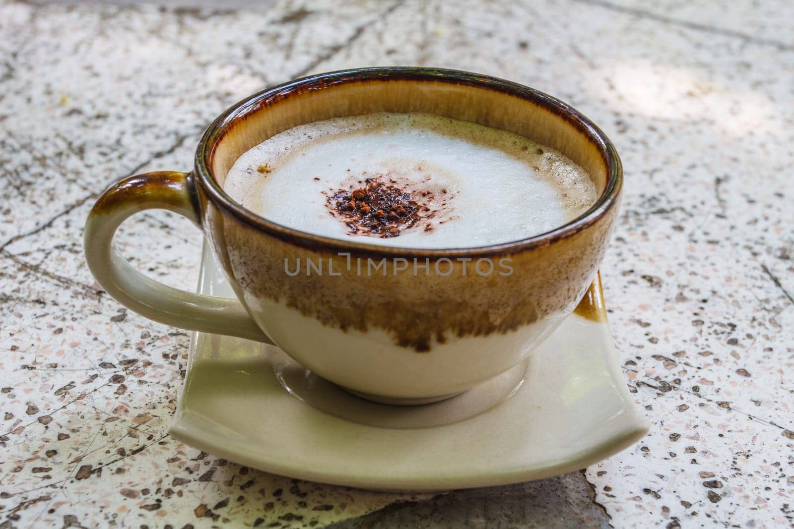 Close up cappuccino coffee on marble table
