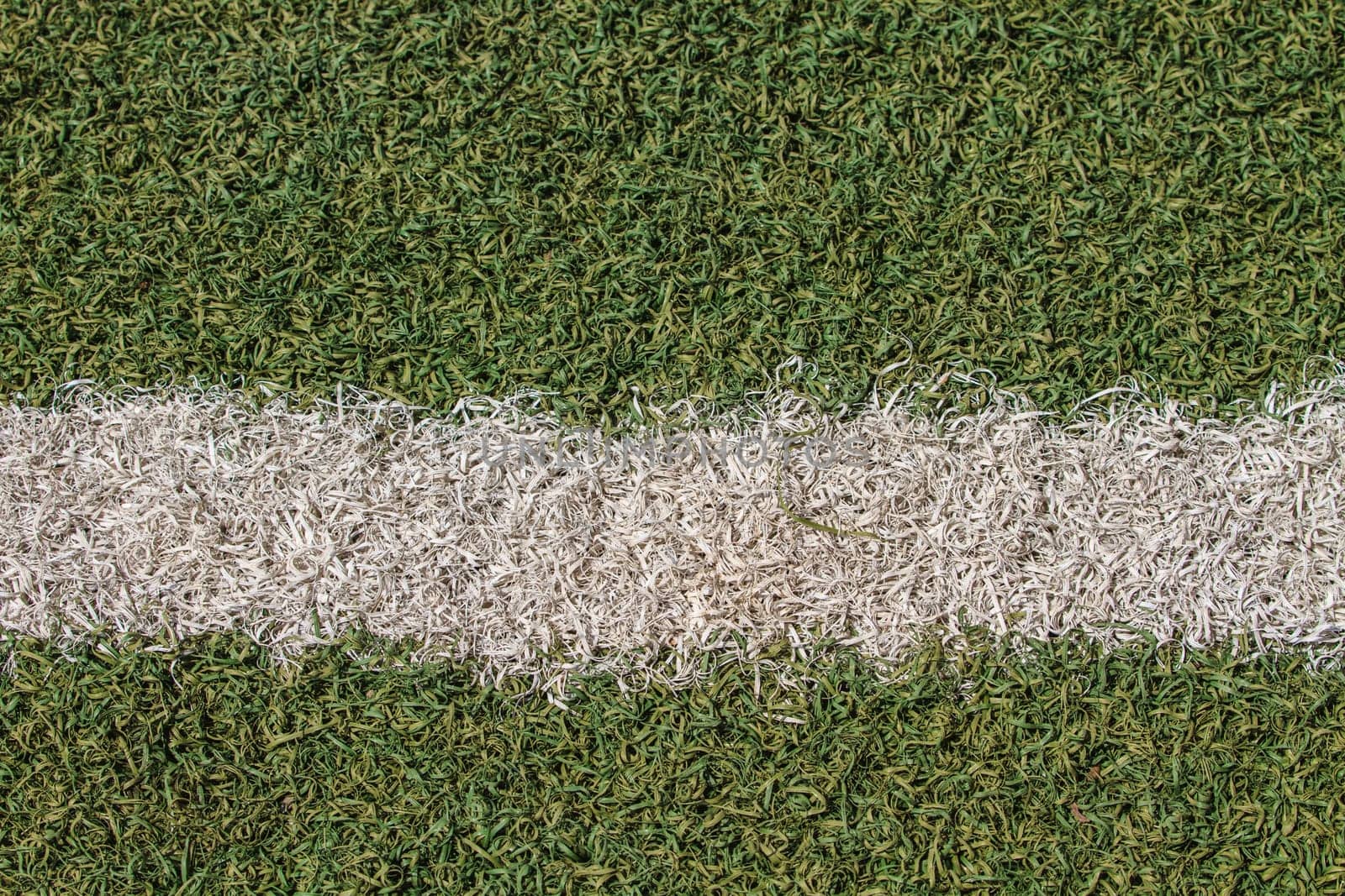 White stripe on the green soccer field from top view
