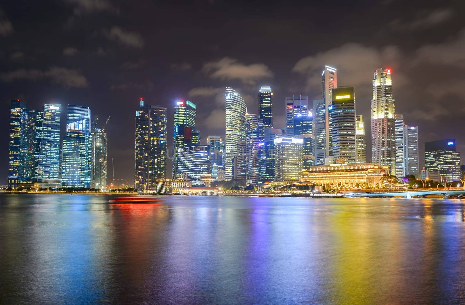Illuminated cityscape of Singapore Downtown Core district with colorful evening sky in background