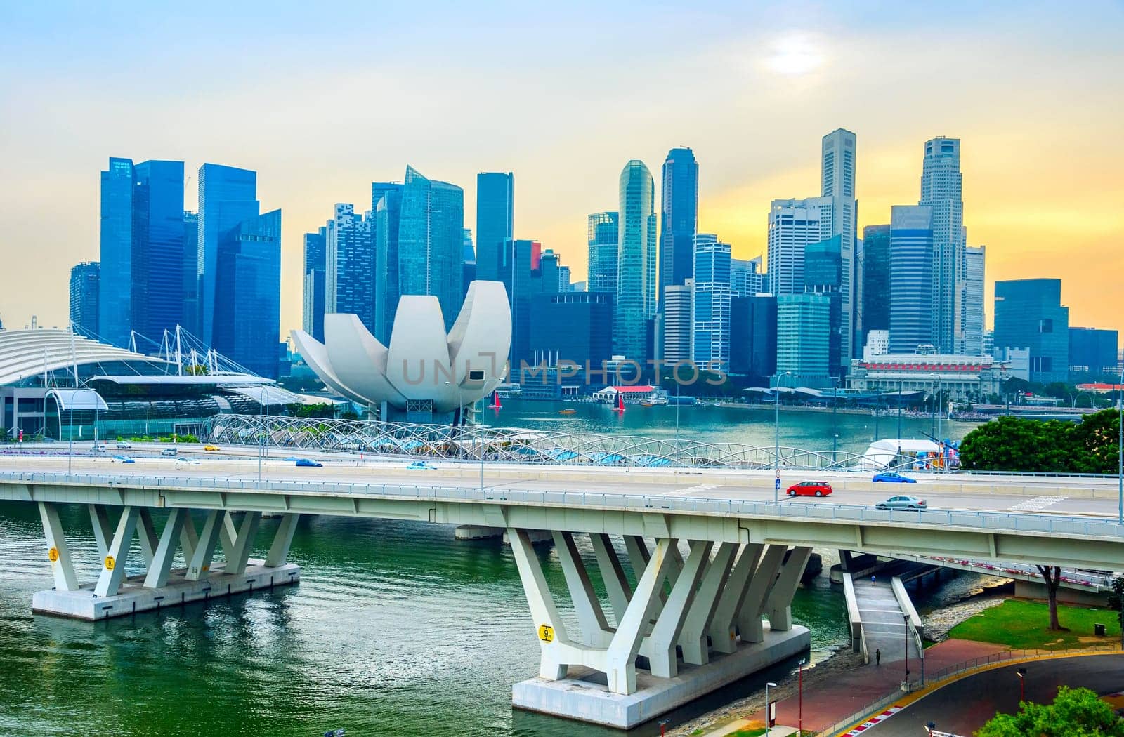 Singapore Marina Bay skyline with Artsience museum and modern transportation bridge at sunset