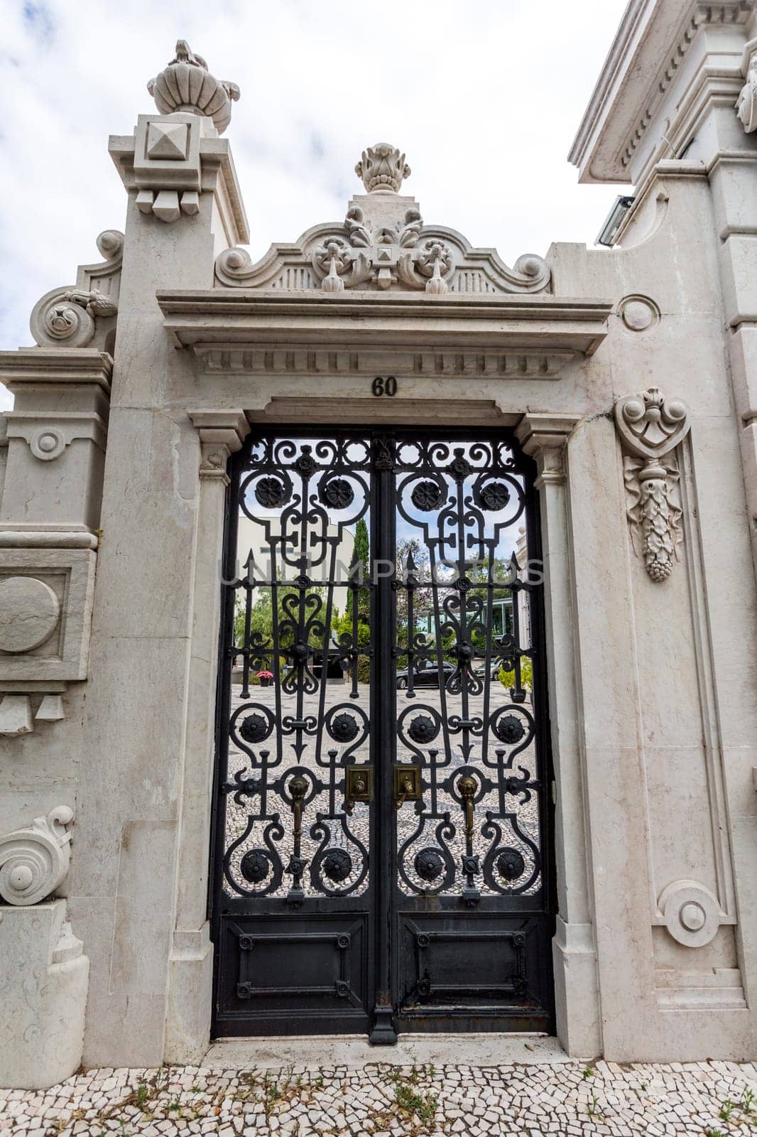 Detail of the gate to the gardens of the sumptuous neoclassical Vale Flor Palace built in early 20th century in Lisbon, Portugal