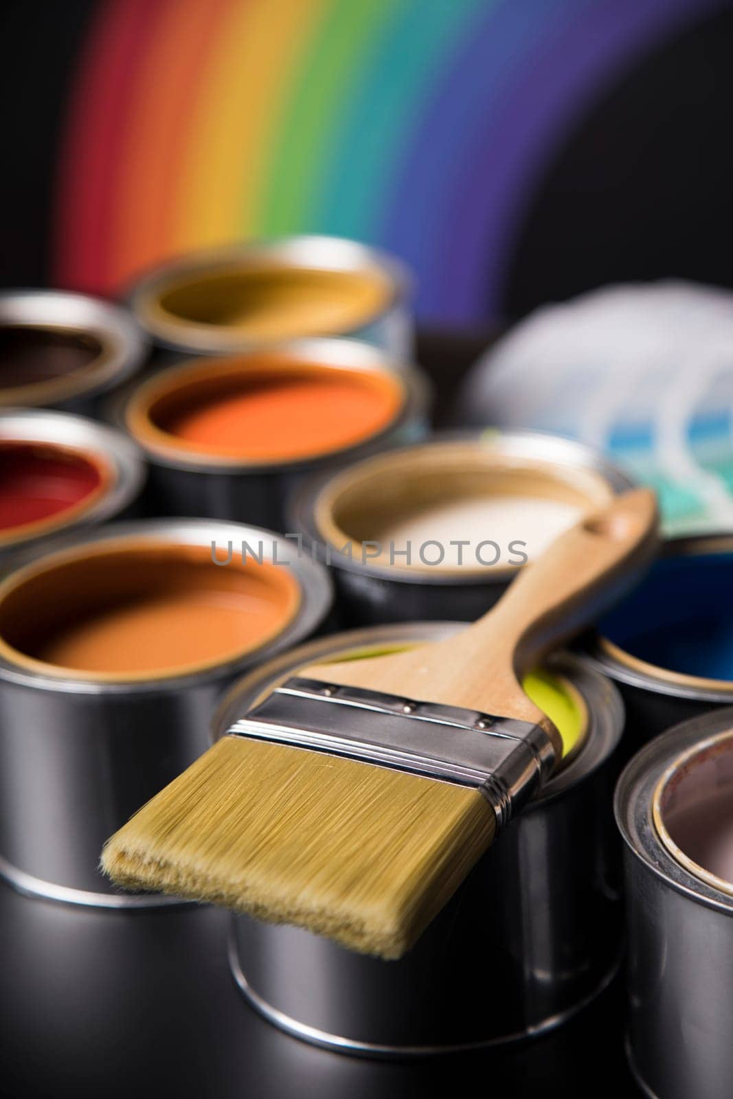 Paintbrush on cans with color