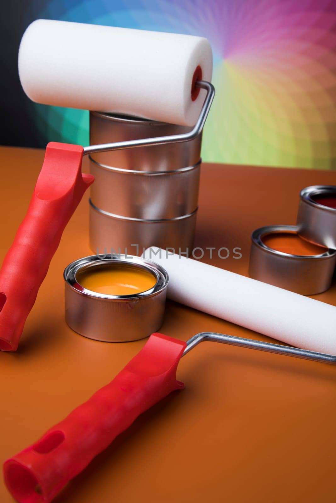 Paintbrush on cans with color