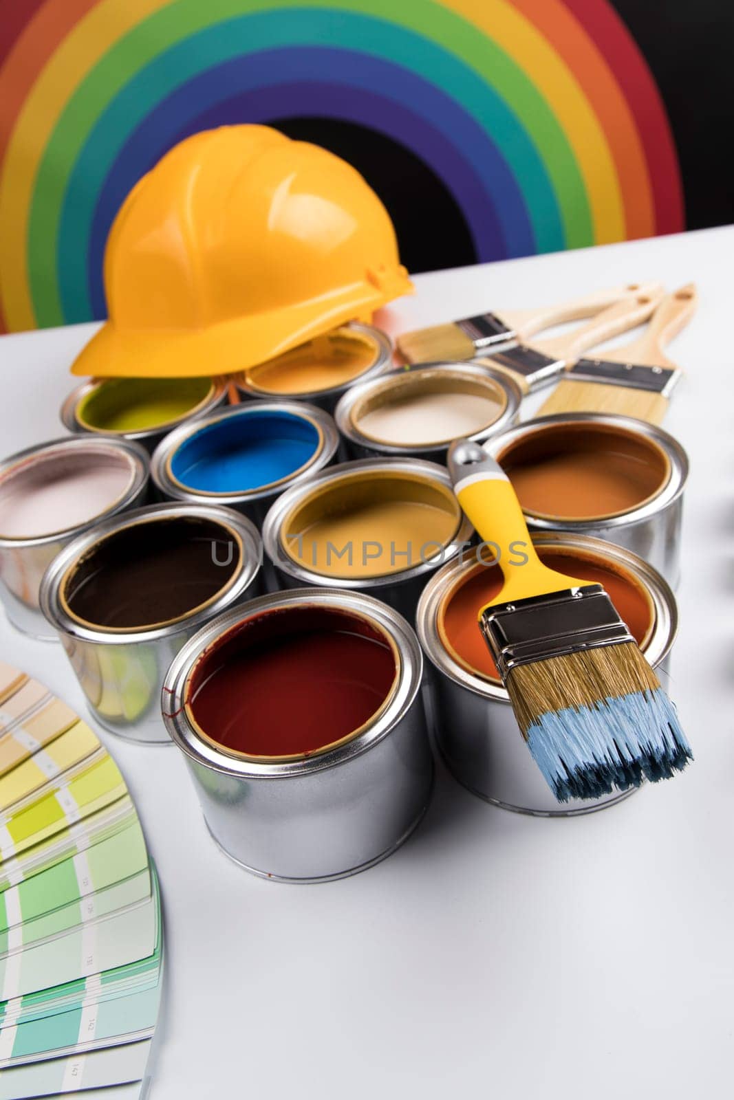 Metal tin cans with color paint and paintbrush