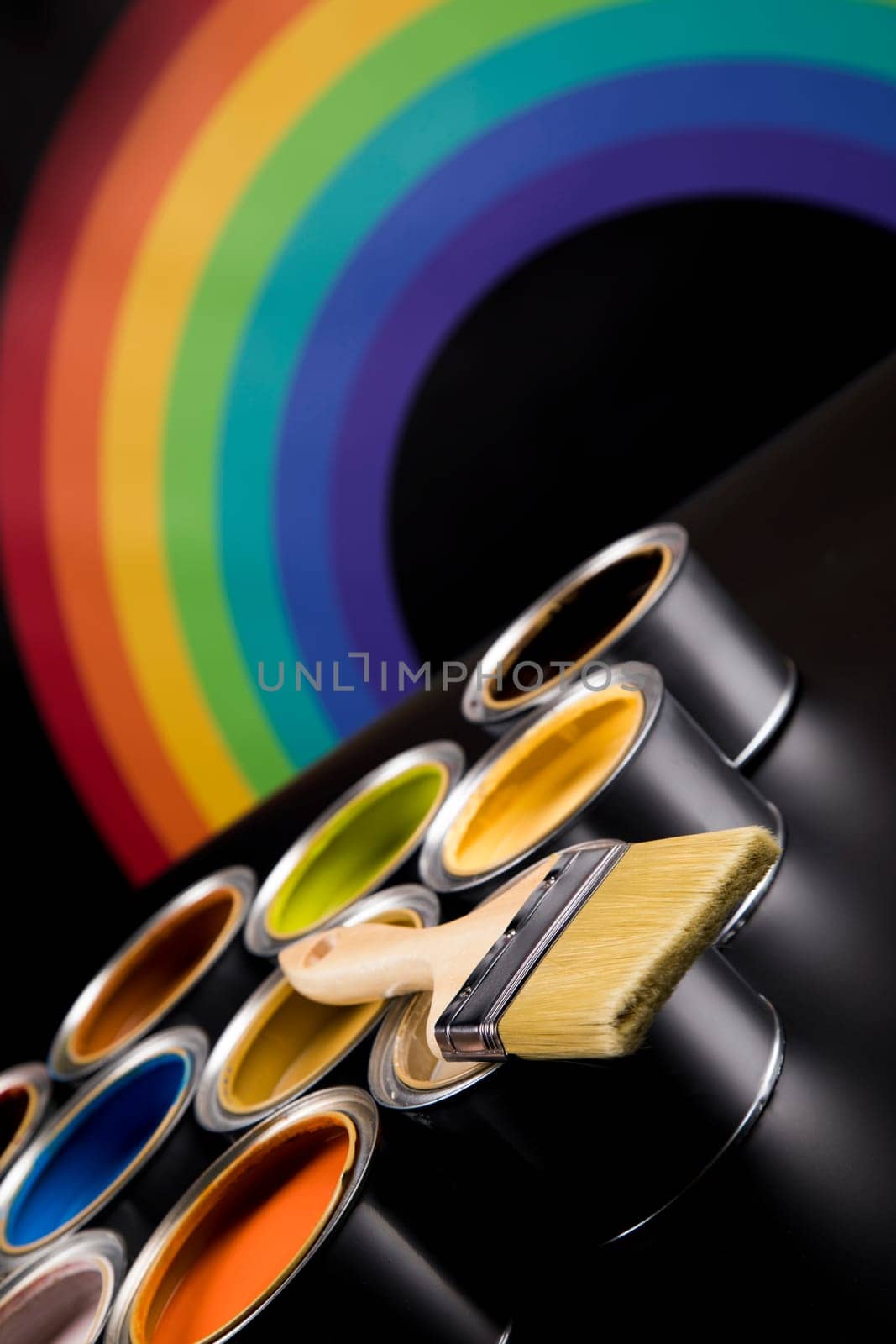 Metal tin cans with color paint and paintbrush