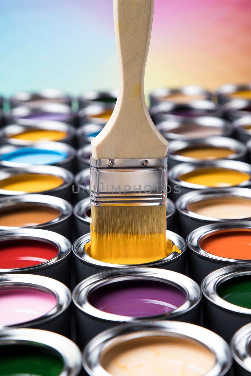 Metal tin cans with color paint and paintbrush