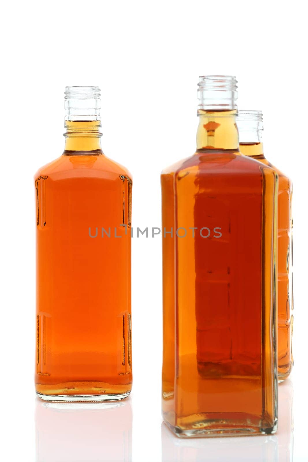 Glass bottle of whiskey on a white background