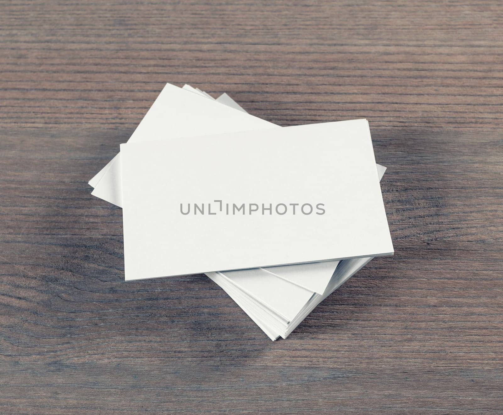 Photo of blank business cards on wooden background. Template for branding identity.