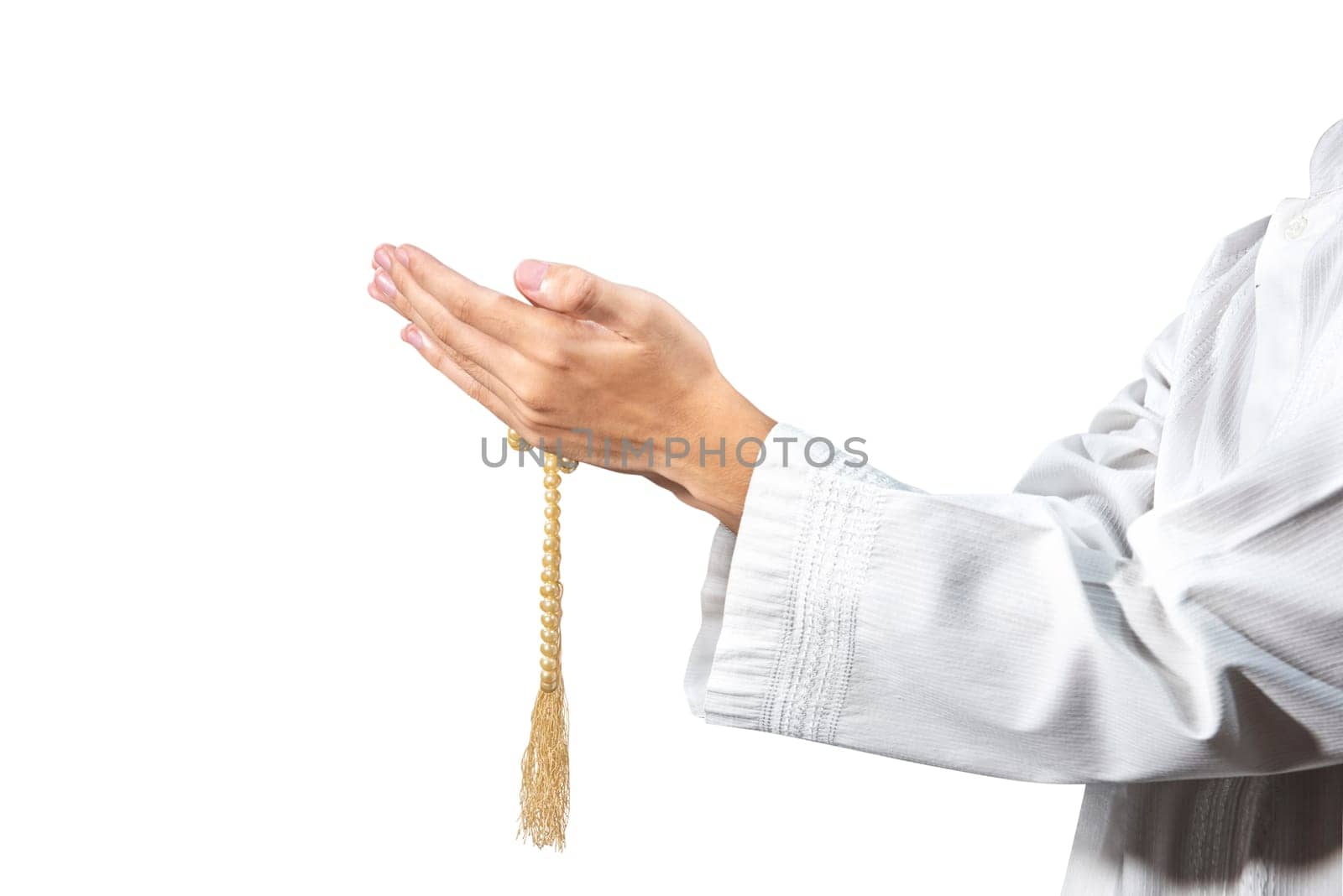 Muslim man praying with prayer beads on his hands isolated over white background