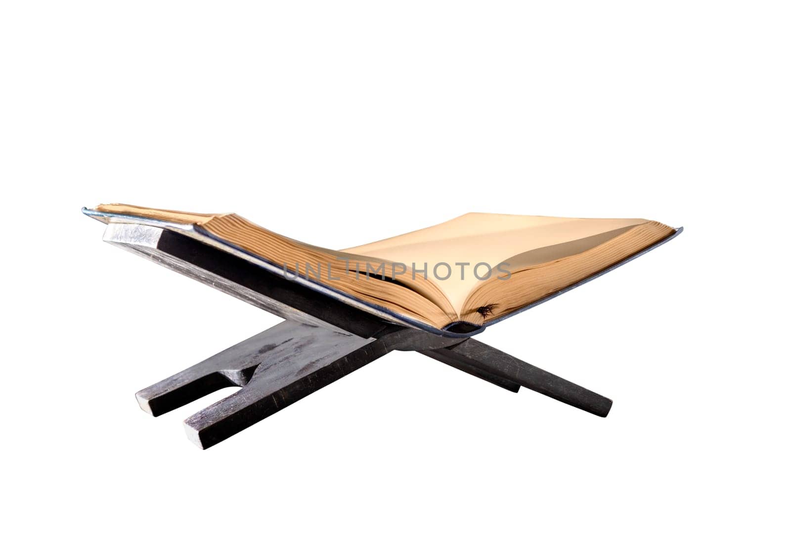 Quran open on wooden placemat isolated over white background