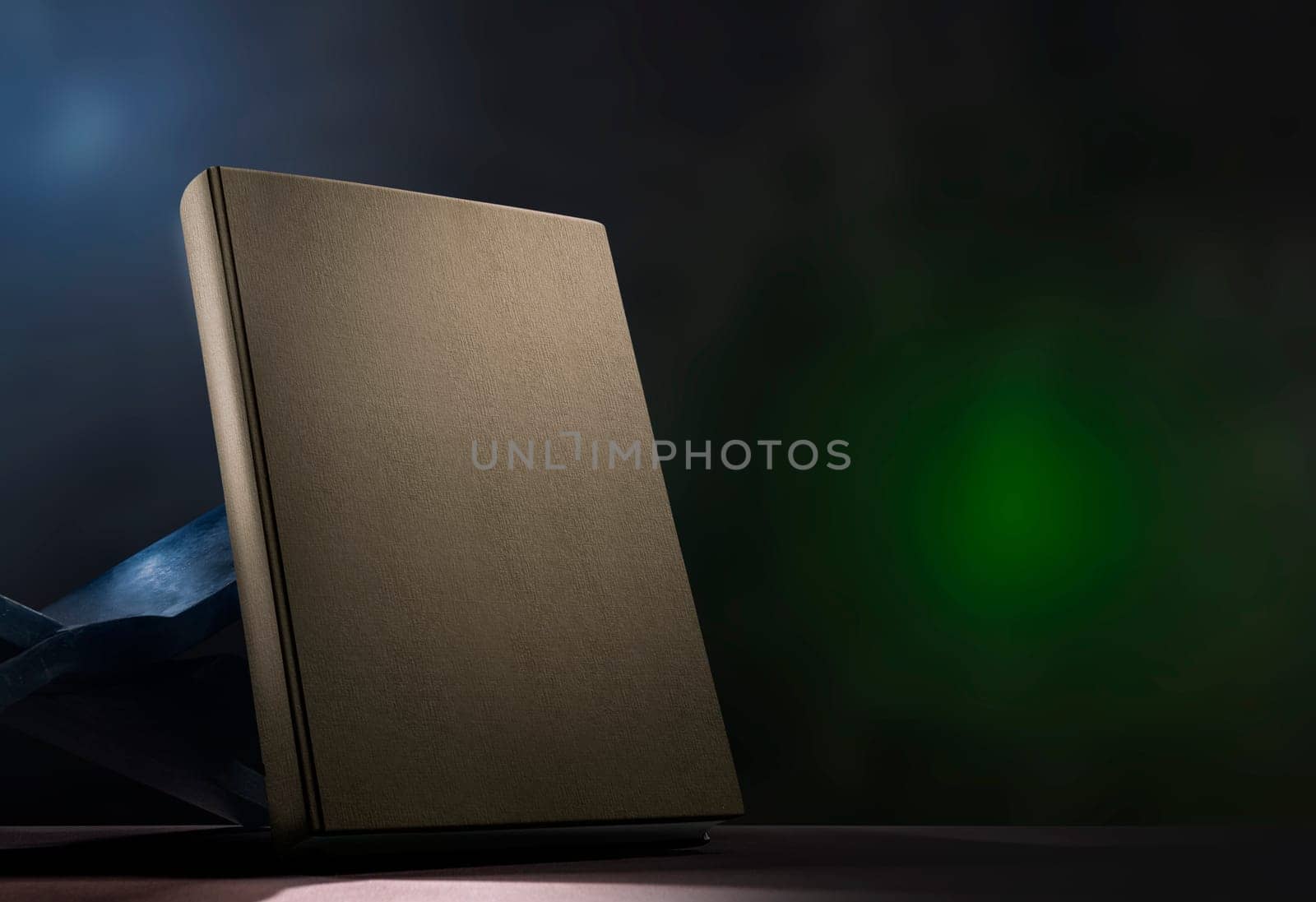 Quran and wooden placemat on the table over black background