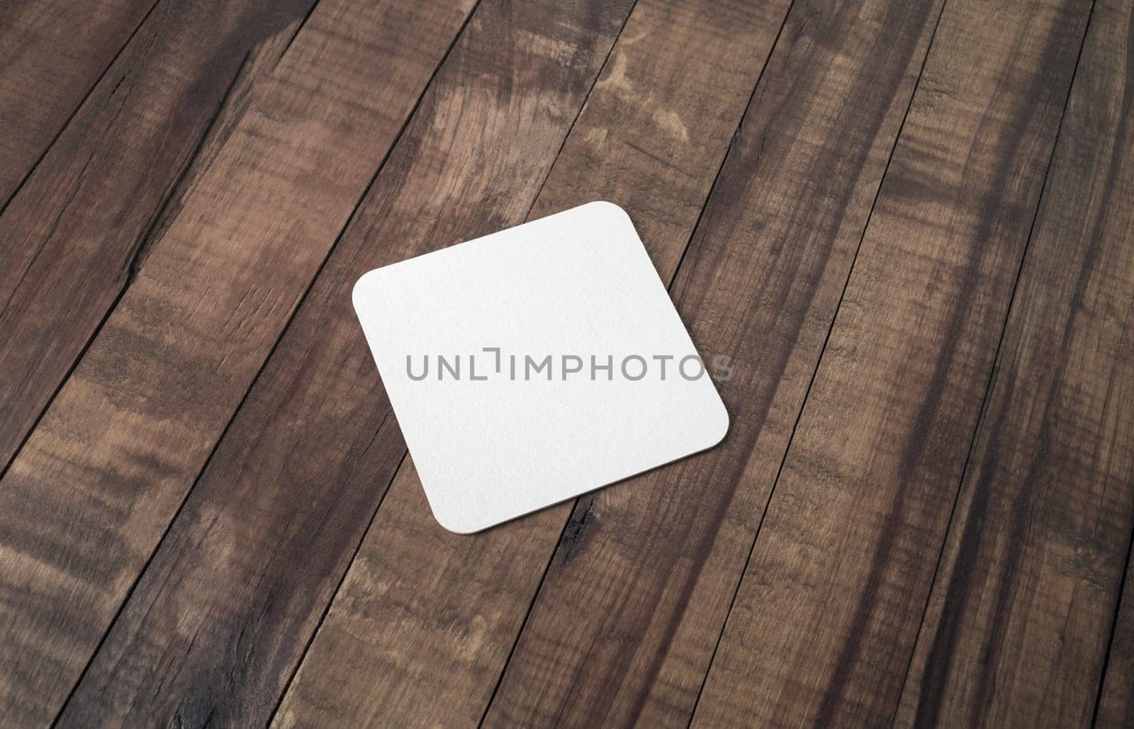 Blank beer coaster on wood table background.