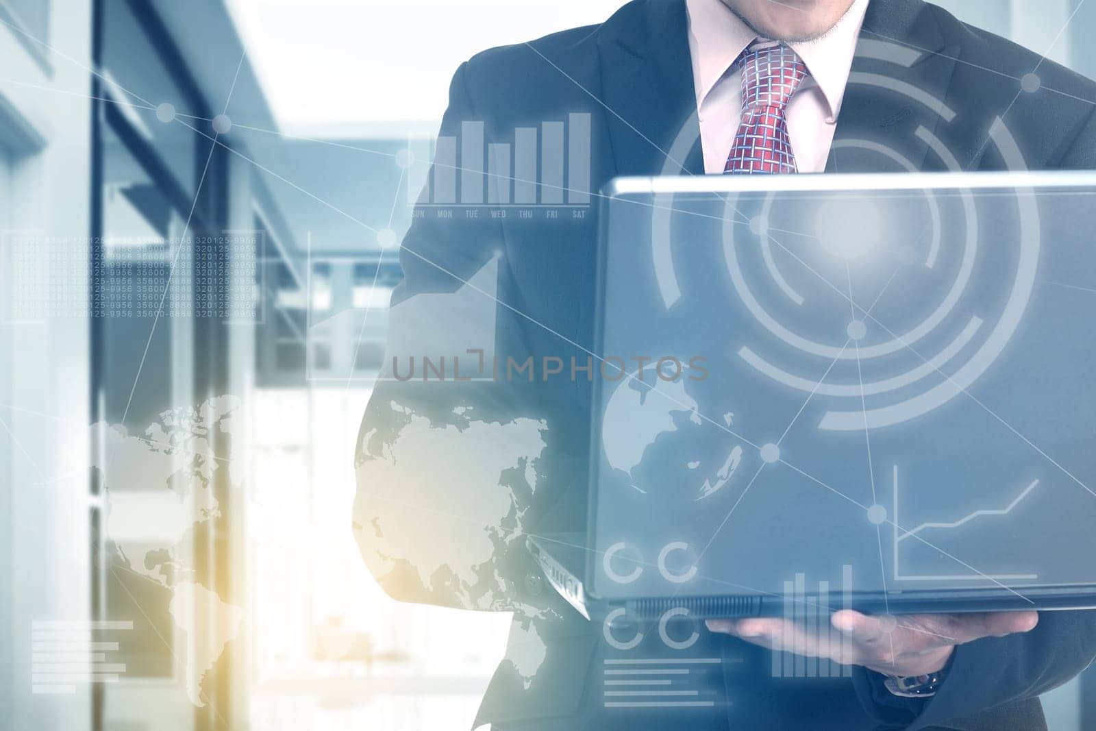 Businessman holding laptop with his hand with virtual screen which display the interface of financial chart and world maps. Digital technology concept