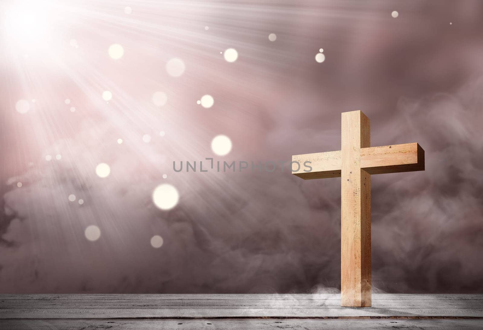 Christian cross on the wooden table with light over bright background