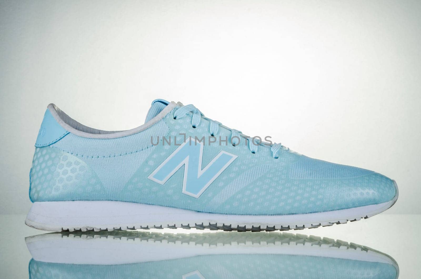 New Balance sports shoes isolated on gradient background